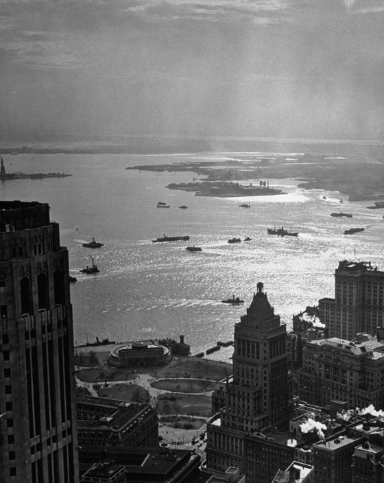 An aerial view of Battery Park and out across the sunlit waters of New York Harbor, 1946.