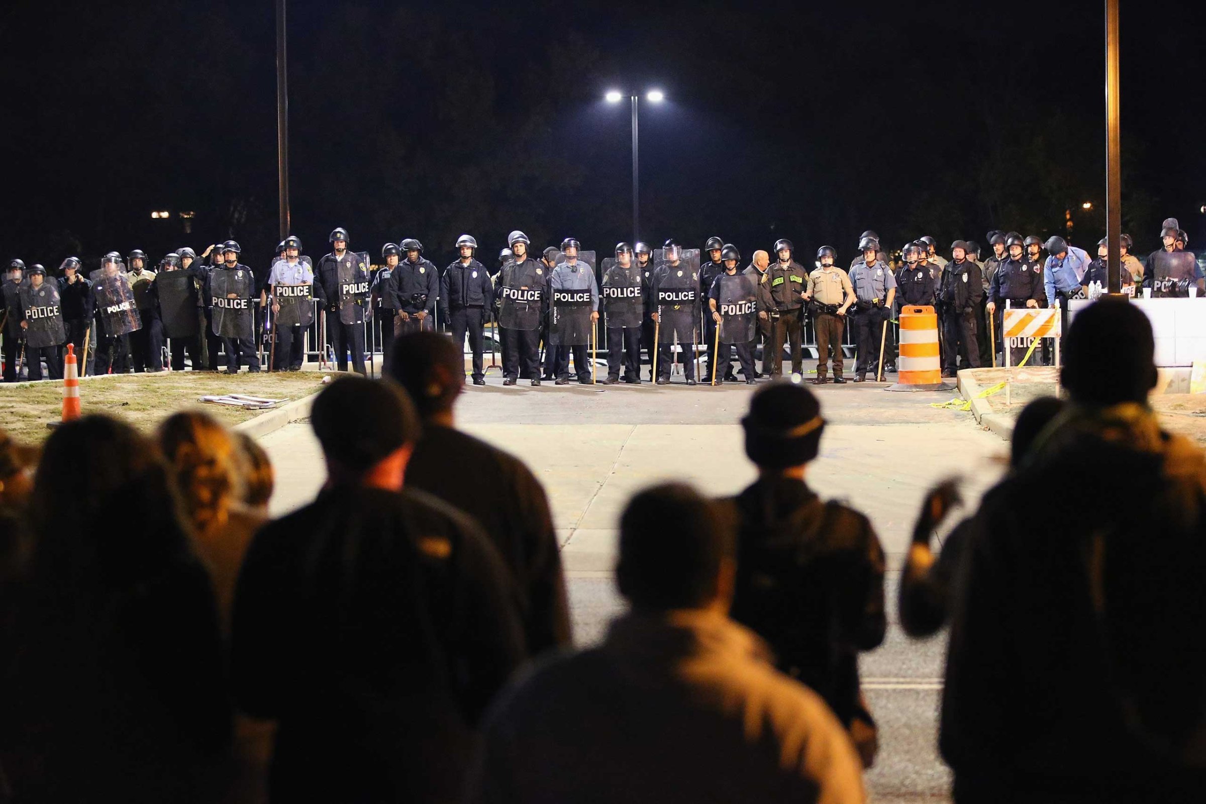 Police face off with demonstrators outside the police station as protests continue in the wake of 18-year-old Michael Brown's death on Oct. 22, 2014 in Ferguson, Missouri.