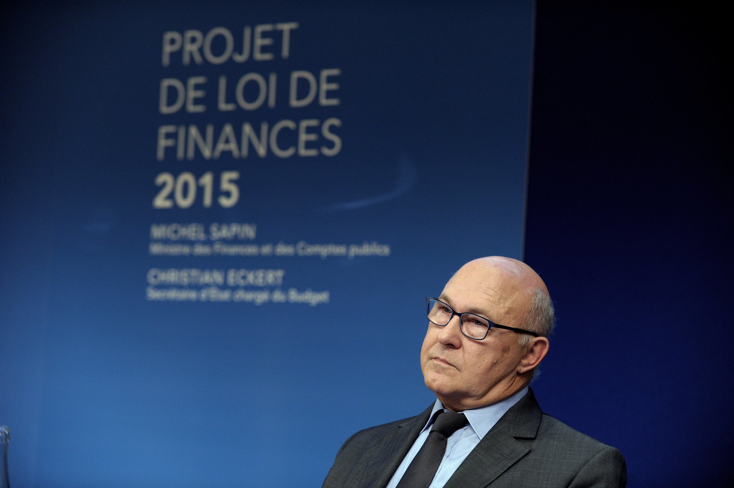 French Finance Minister Michel Sapin listens during the presentation of France's 2015 draft budget on October 1, 2014 at the Economy Ministry in Paris.