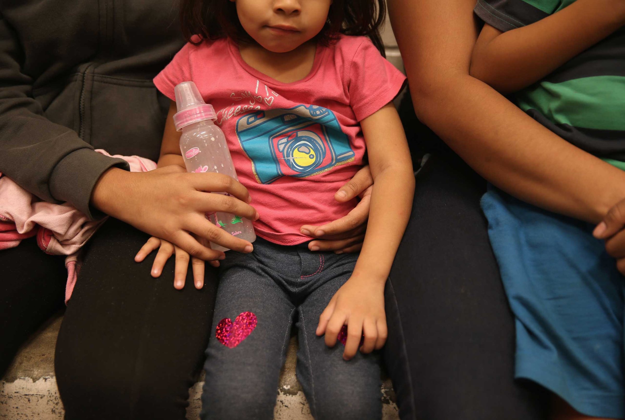 Women and children sit in a holding cell at a U.S. Border Patrol processing center after being detained by agents near the U.S.-Mexico border on Sept. 8, 2014 near McAllen, Texas.