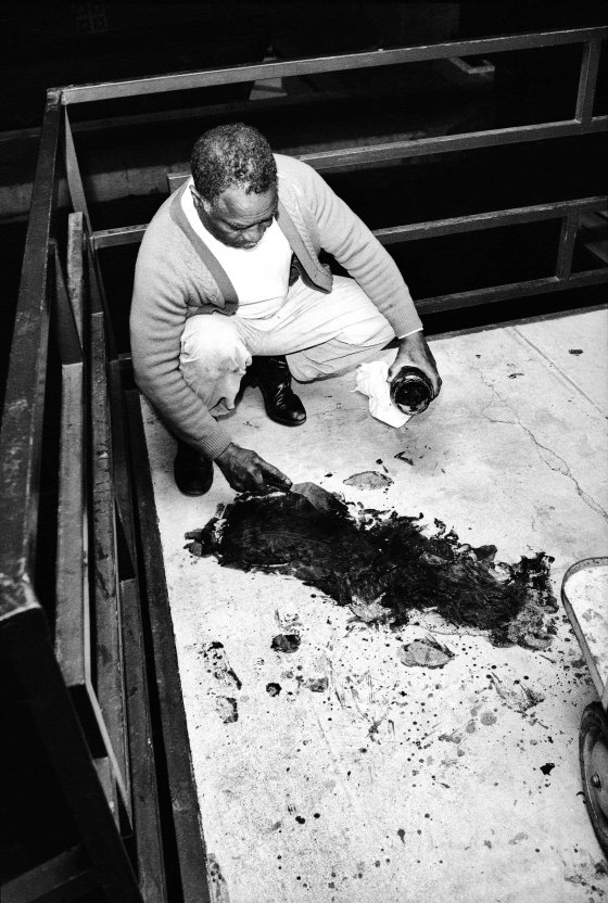Theatrice Bailey attempts to clean blood from the balcony, hours after the 6 PM shooting of Dr. King. 