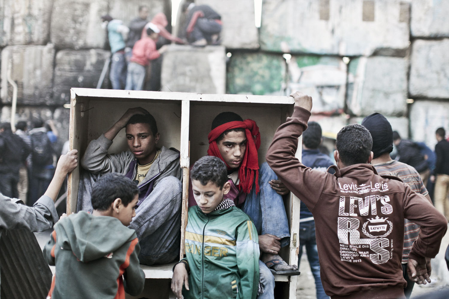 Protesters take shelter during clashes with the Egyptian police on the second anniversary of the revolution, Cairo, January, 2013.