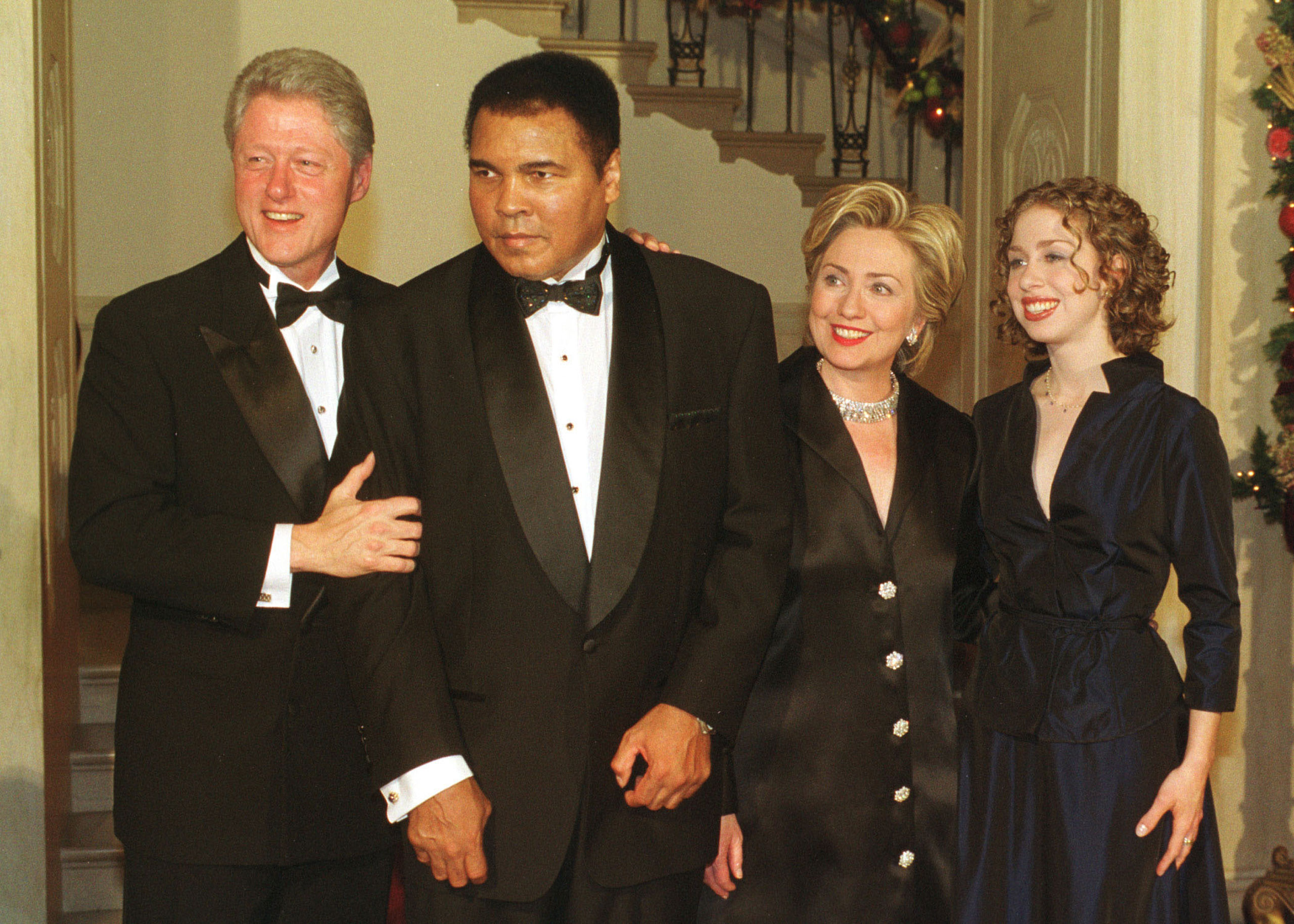 The former First Family poses for a photo with Muhammad Ali at the White House Millennium Dinner on Dec. 31, 1999.