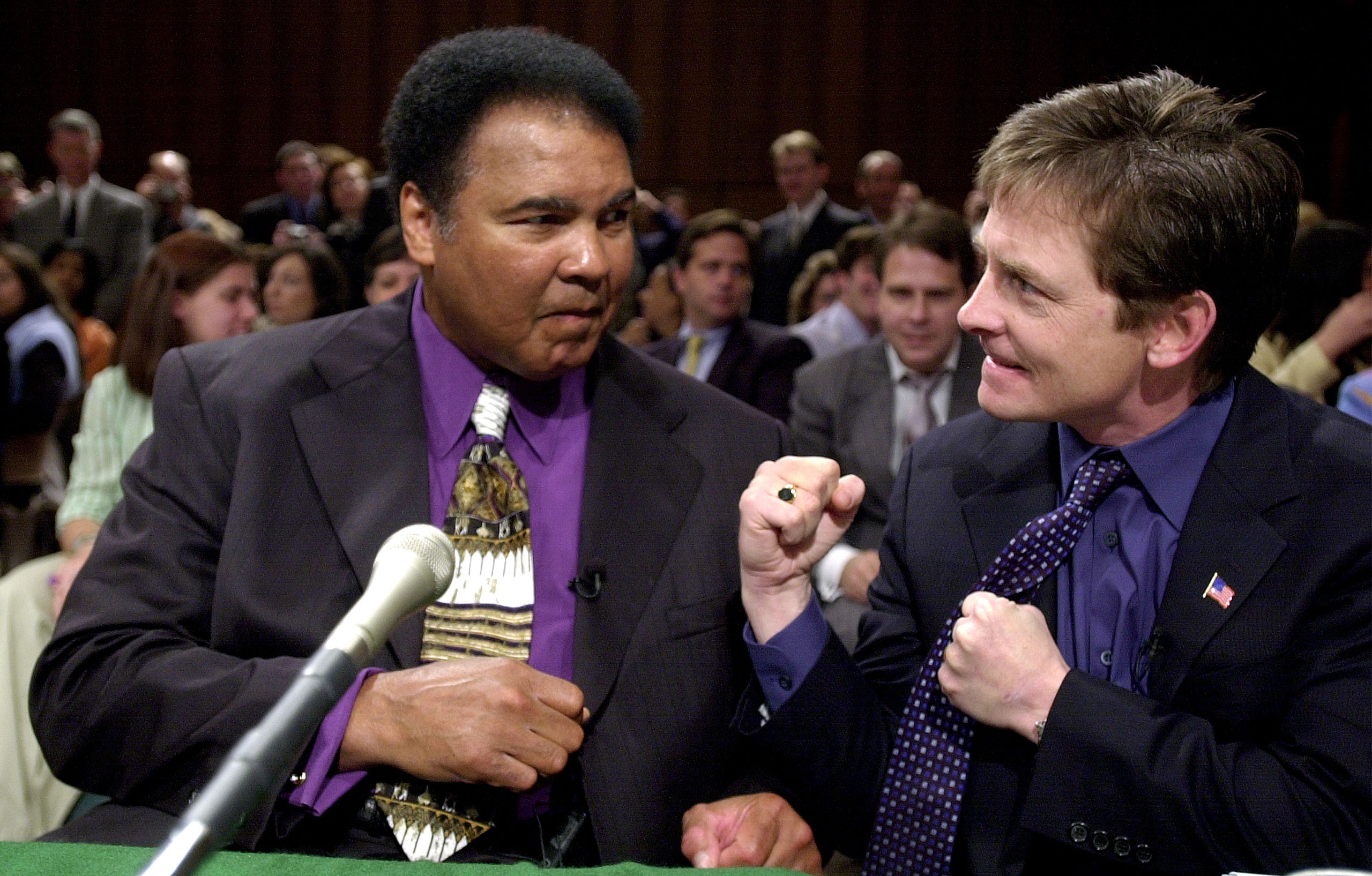 Muhammad Ali and actor Michael J. Fox before the start of a Senate subcommittee on Labor, Health, Human Services and Education hearing on Parkinson's Disease on Capitol Hill in Washington on May 22, 2002.