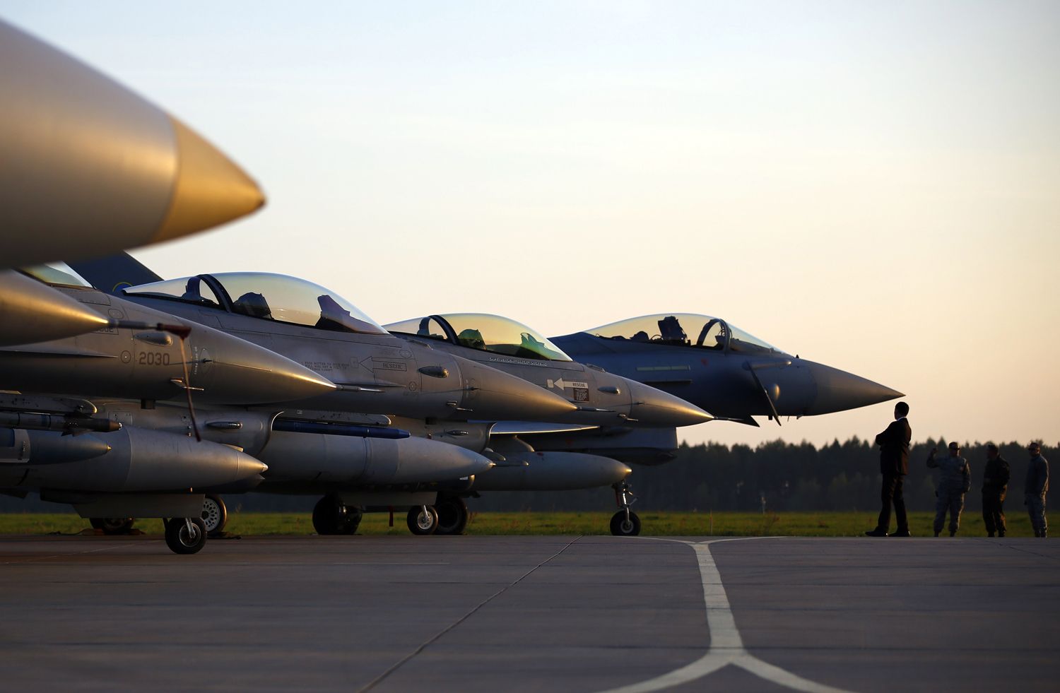 Military aircrafts are seen on the tarmac during a visit of new NATO Secretary-General Stoltenberg of Norway at Lask air base