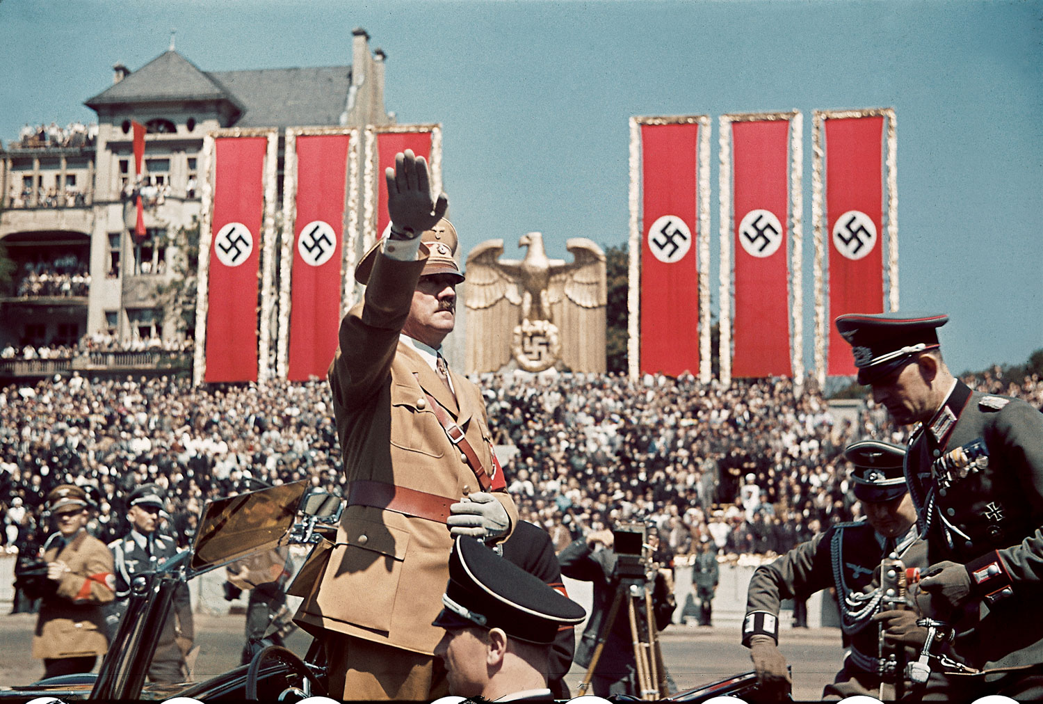 Adolf Hitler salutes troops of the Condor Legion who fought alongside Spanish Nationalists in the Spanish Civil War, during a rally upon their return to Germany, 1939.