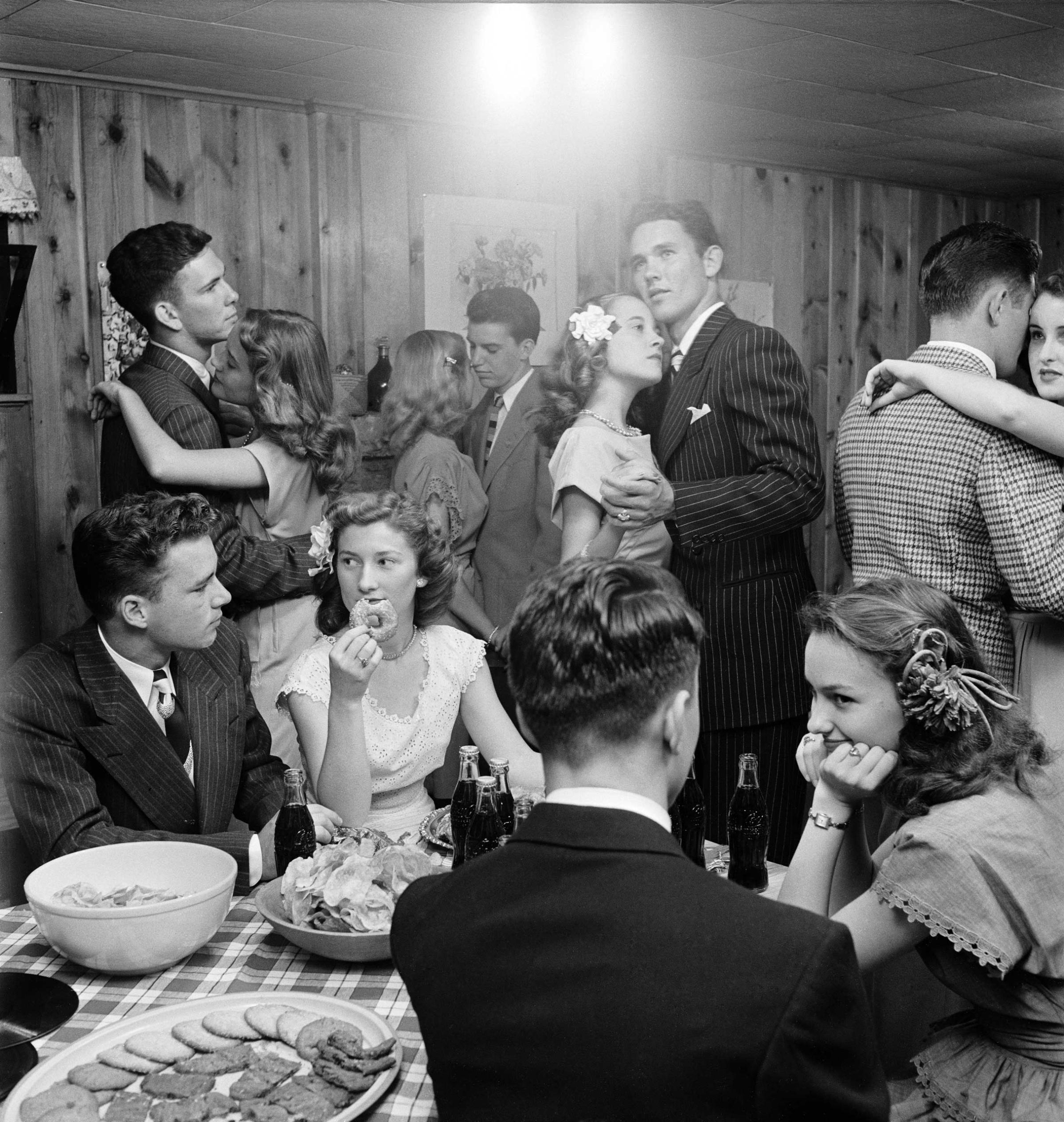 Teenagers at a party in 1947 in Tulsa, Oklahoma; LIFE reported that they "munch doughnuts and sip cokes whenever they are not dancing with serious faces to sentimental music."