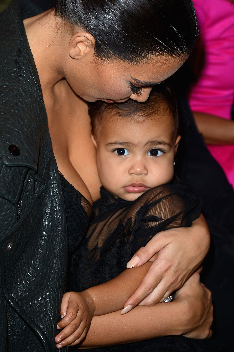 Kim Kardashian and baby North West attend the Givenchy show as part of the Paris Fashion Week on September 28, 2014 in Paris, France.