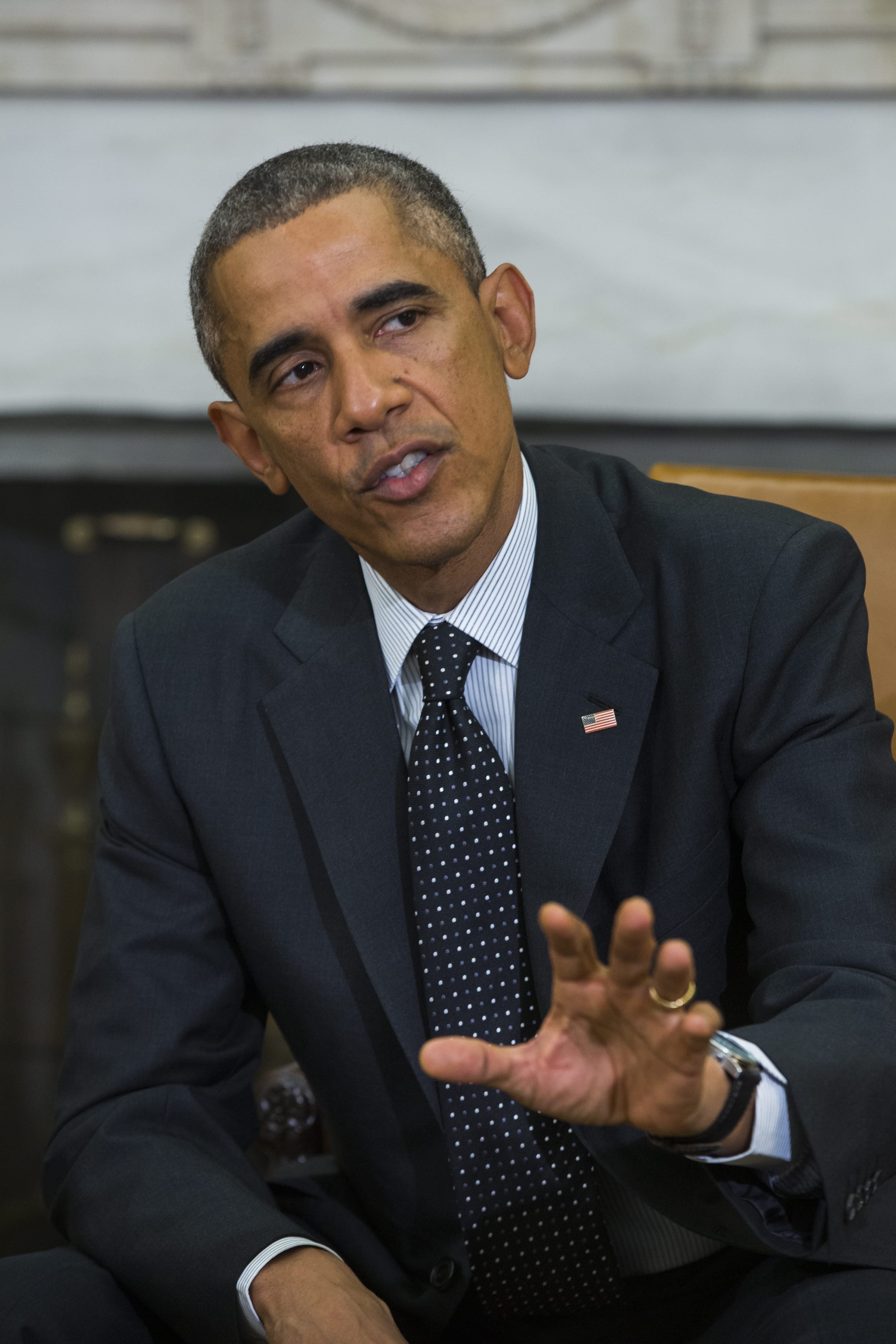 President Barack Obama speaks to the media after holding a meeting with his newly-appointed 'Ebola Response Coordinator' Ron Klain, along with other members of the team coordinating the Obama administration's ebola response efforts, in the Oval Office of the White House in Washington on Oct. 22, 2014.