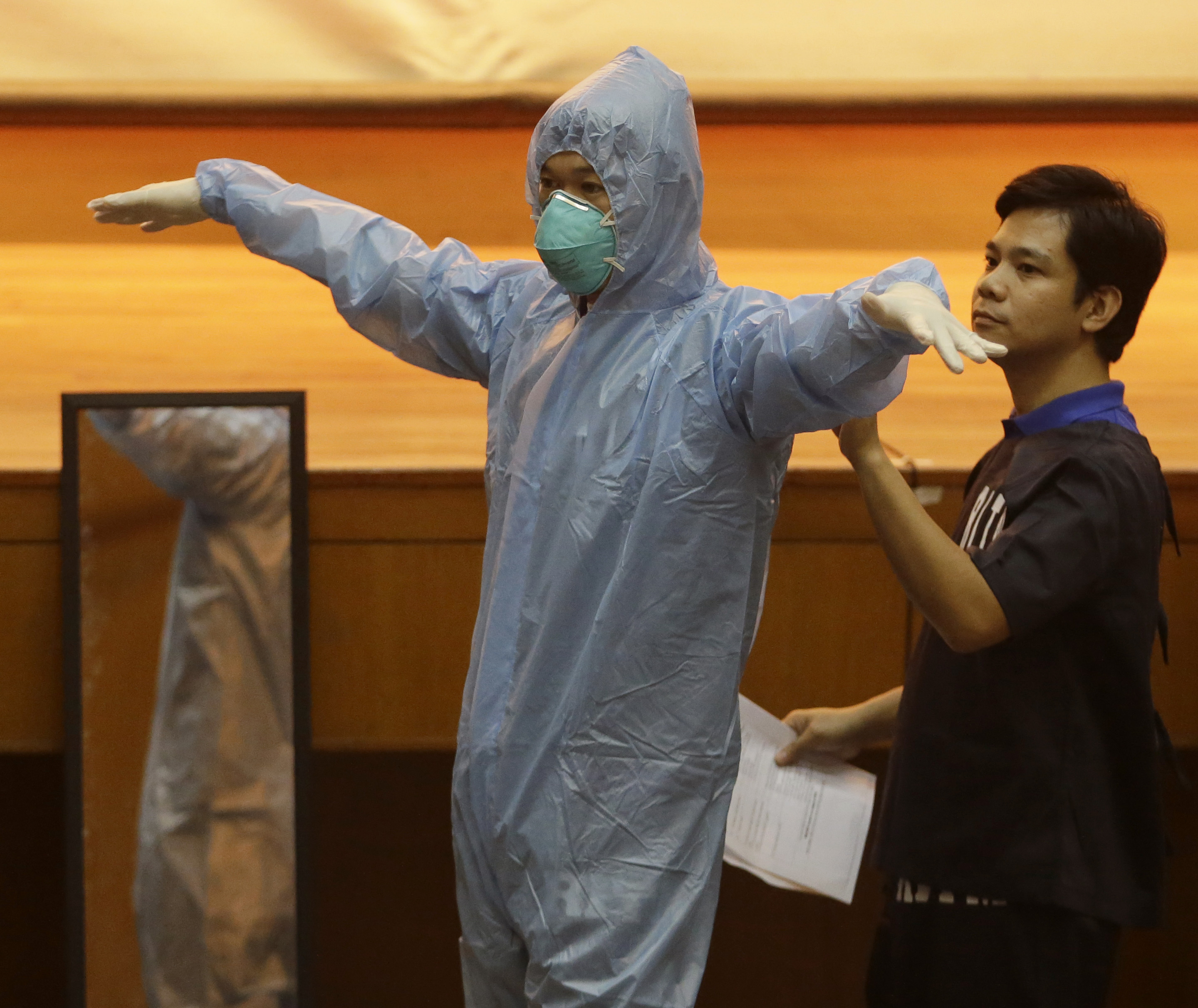 Government health workers practice wearing Ebola protective suits on the first day of training on hospital management for Ebola virus at the Research Institute for Tropical Medicine in the Philippine city of Muntinlupa on Oct. 28, 2014 (Bullit Marquez—AP)