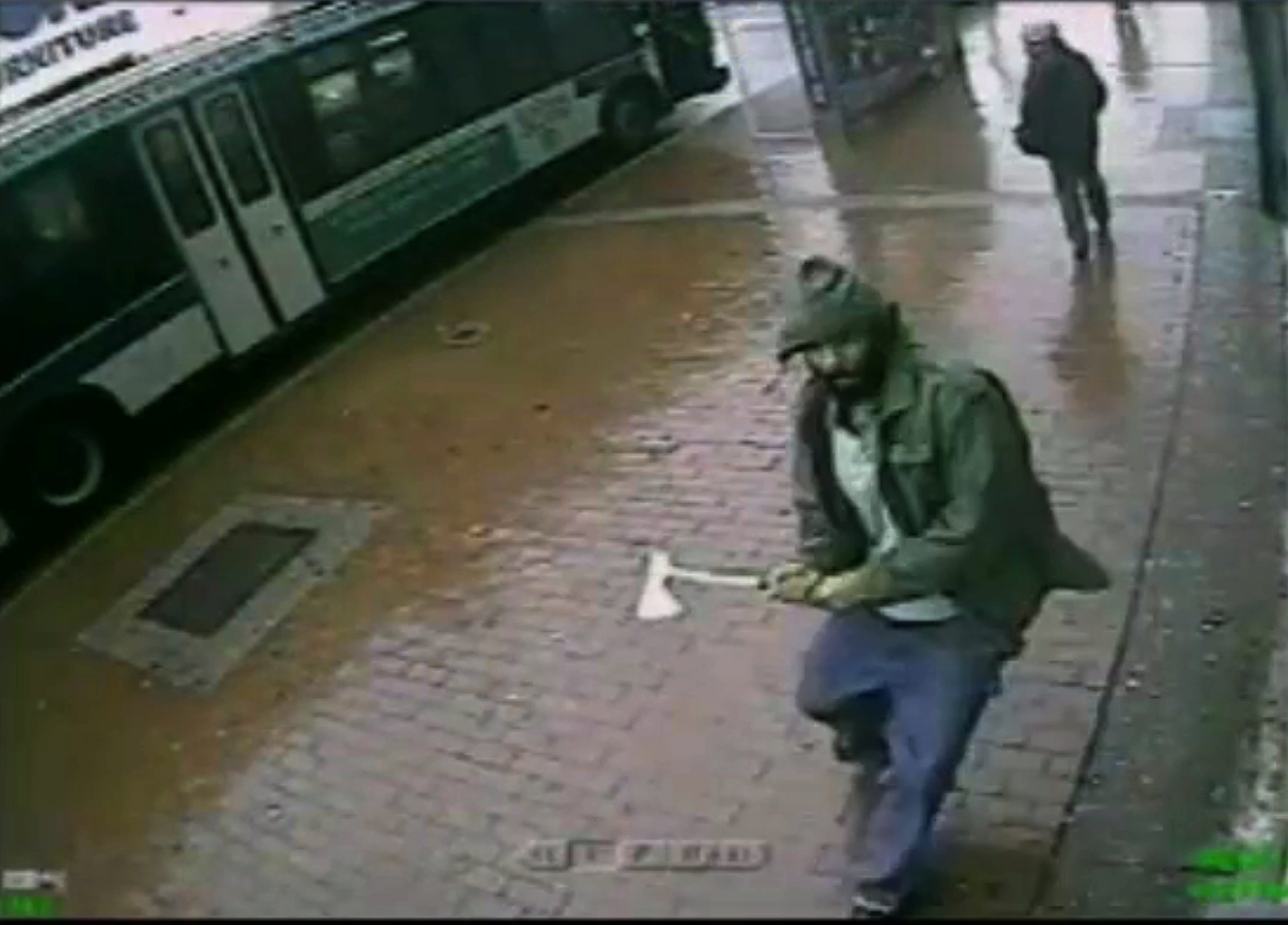 In this frame grab taken from video provided by the New York Police Department, an unidentified man approaches New York City police officers with a hatchet, Thursday, Oct. 23, 2014, in the Queens borough of New York. (AP)