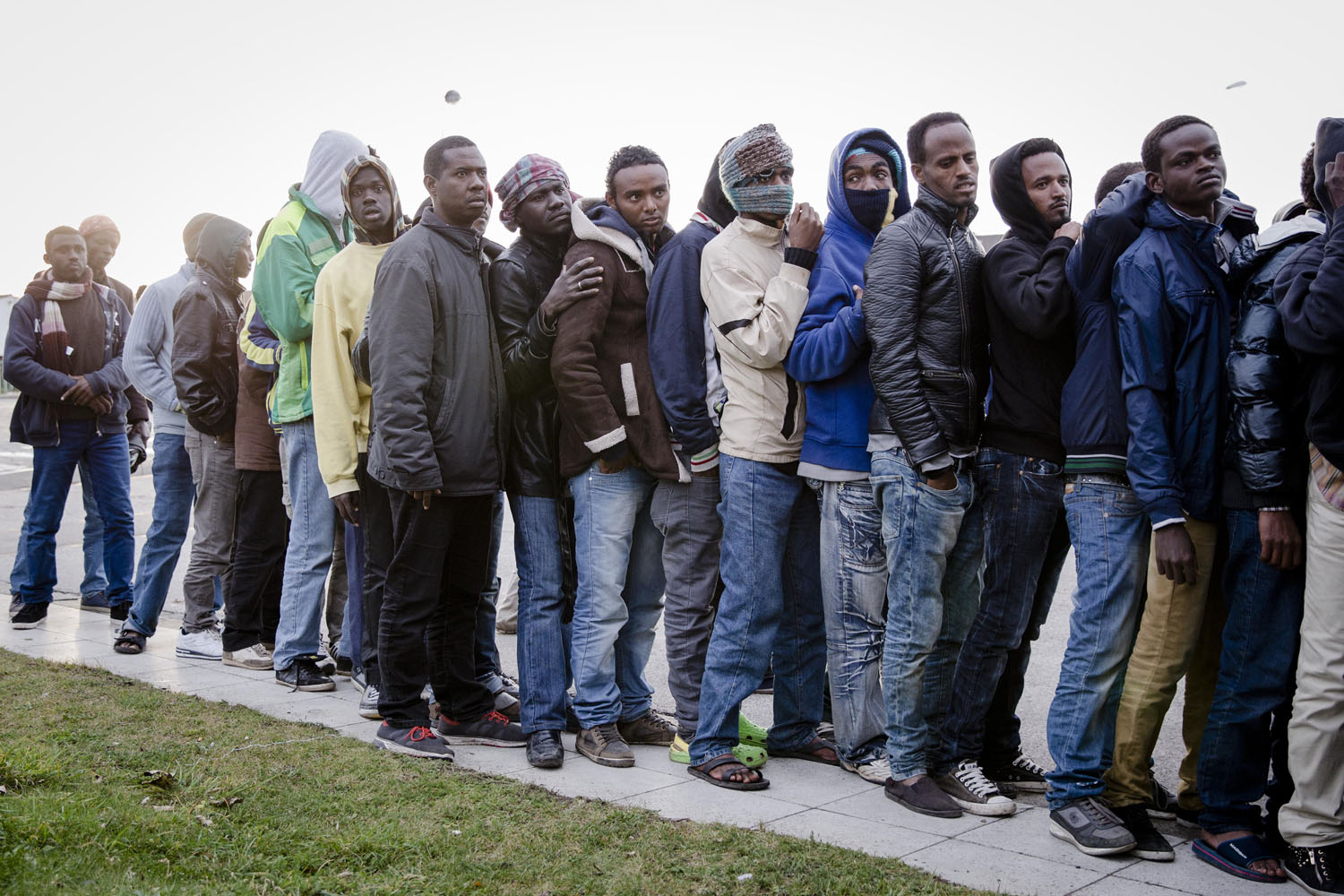 Migrants wait in line for clothes distribution in Calais, France, Oct. 8, 2014.  Resentment and fear have swept the city in the last year, along with a new wave of migrants hoping to cross illegally into Britain, which they see as a better place than France to start a new life.