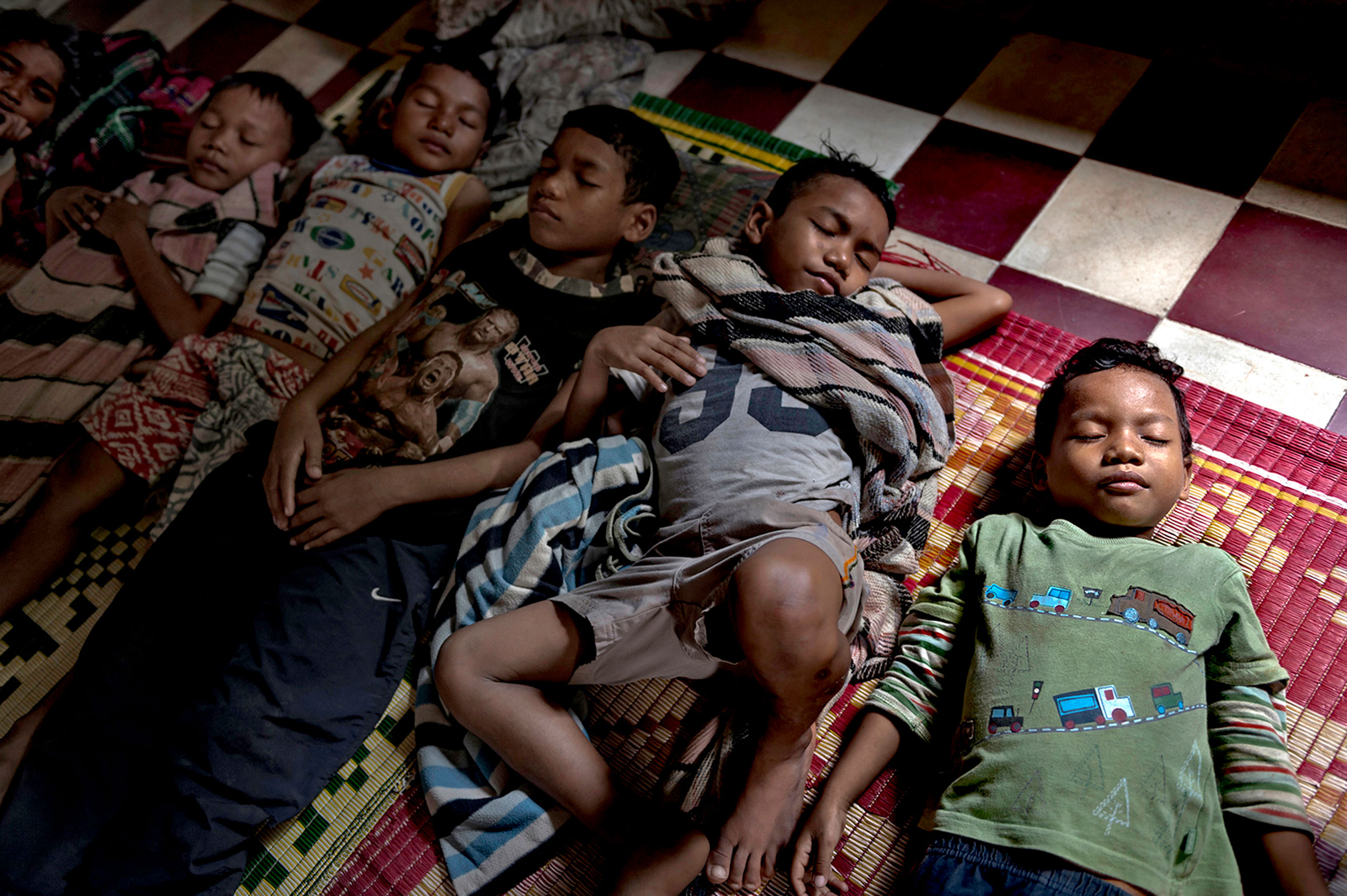 At the Krousa Thmey Center in Phnom Penh, Cambodia, five brothers sleep together on the floor. This is a temporary orphanage or, in reality, safe house for children who have been found abandoned and 
                              wandering the streets. Because space is limited, they cannot stay for long, but for now at least they are given some refuge from the influences of the streets of the city. These brothers range in age from 5 to 12.