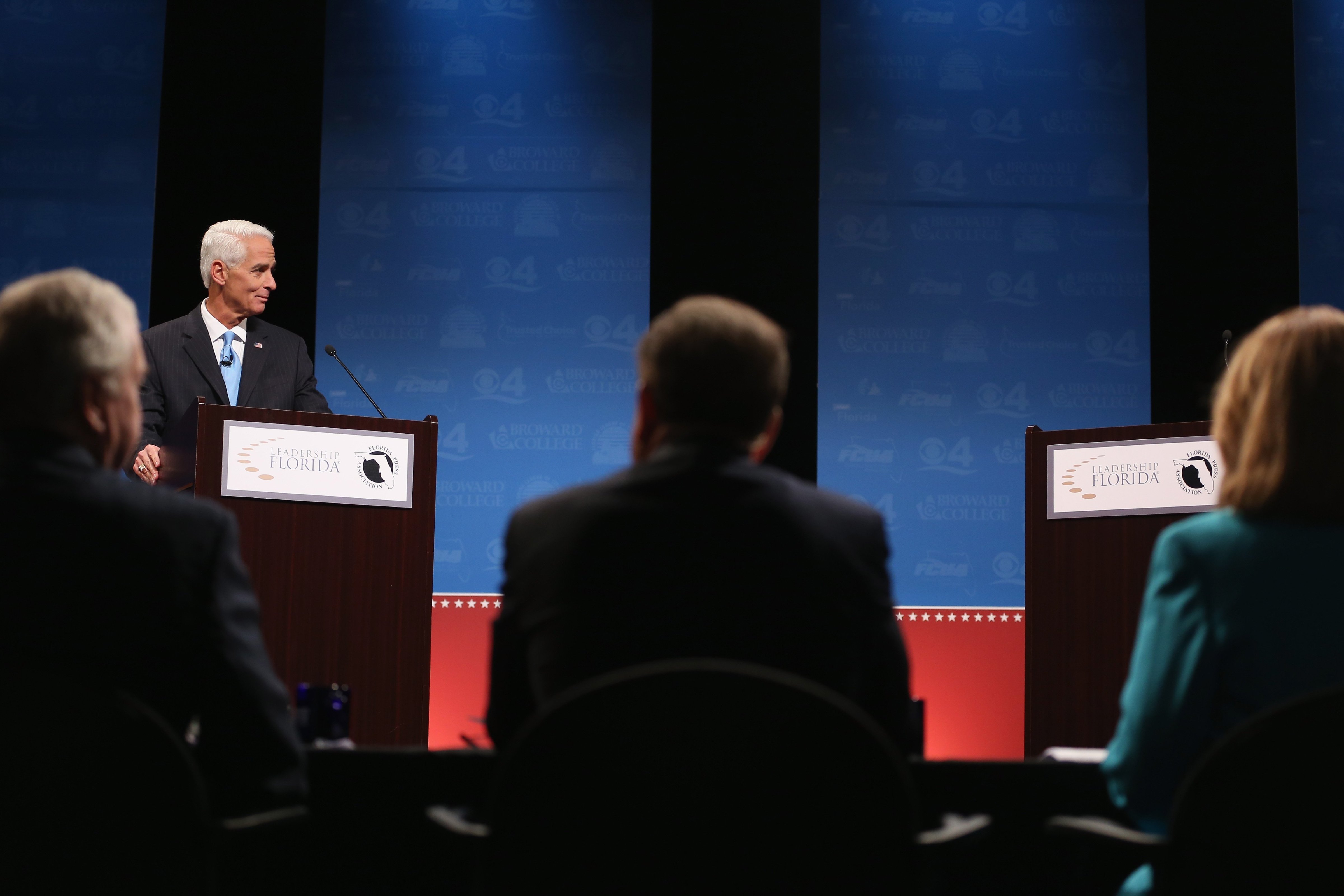 Former Florida Governor and Democratic candidate for Governor Charlie Crist waits next to an empty podium for Republican Florida Governor Rick Scott who delayed his entry onto the stage due to an electric fan that Crist had at his podium at a televised debate at Broward College on Oct. 15, 2014 in Davie, Florida. (Joe Raedle—Getty Images)