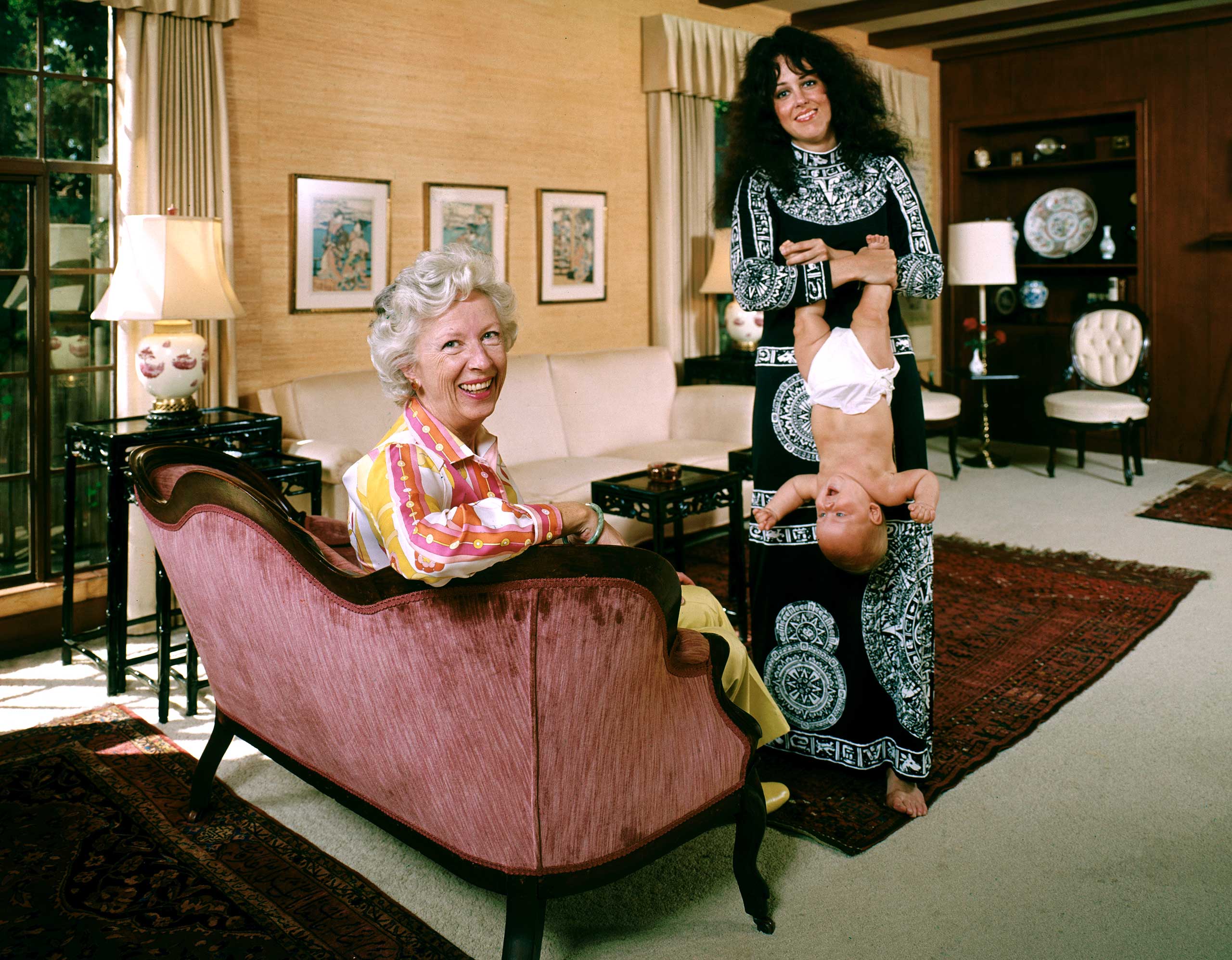 In one of the photos that ultimately ran in LIFE (Olson went back to Palo Alto for a re-shoot), new mom Grace dangles her daughter China by the feet in 1971.