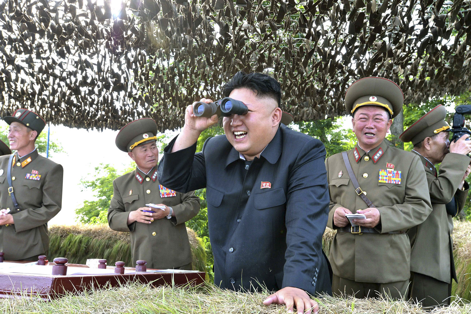 KCNA handout shows North Korean leader Kim Jong Un looking through a pair of binoculars during inspection of Hwa Islet Defence Detachment off east coast of Korean peninsula