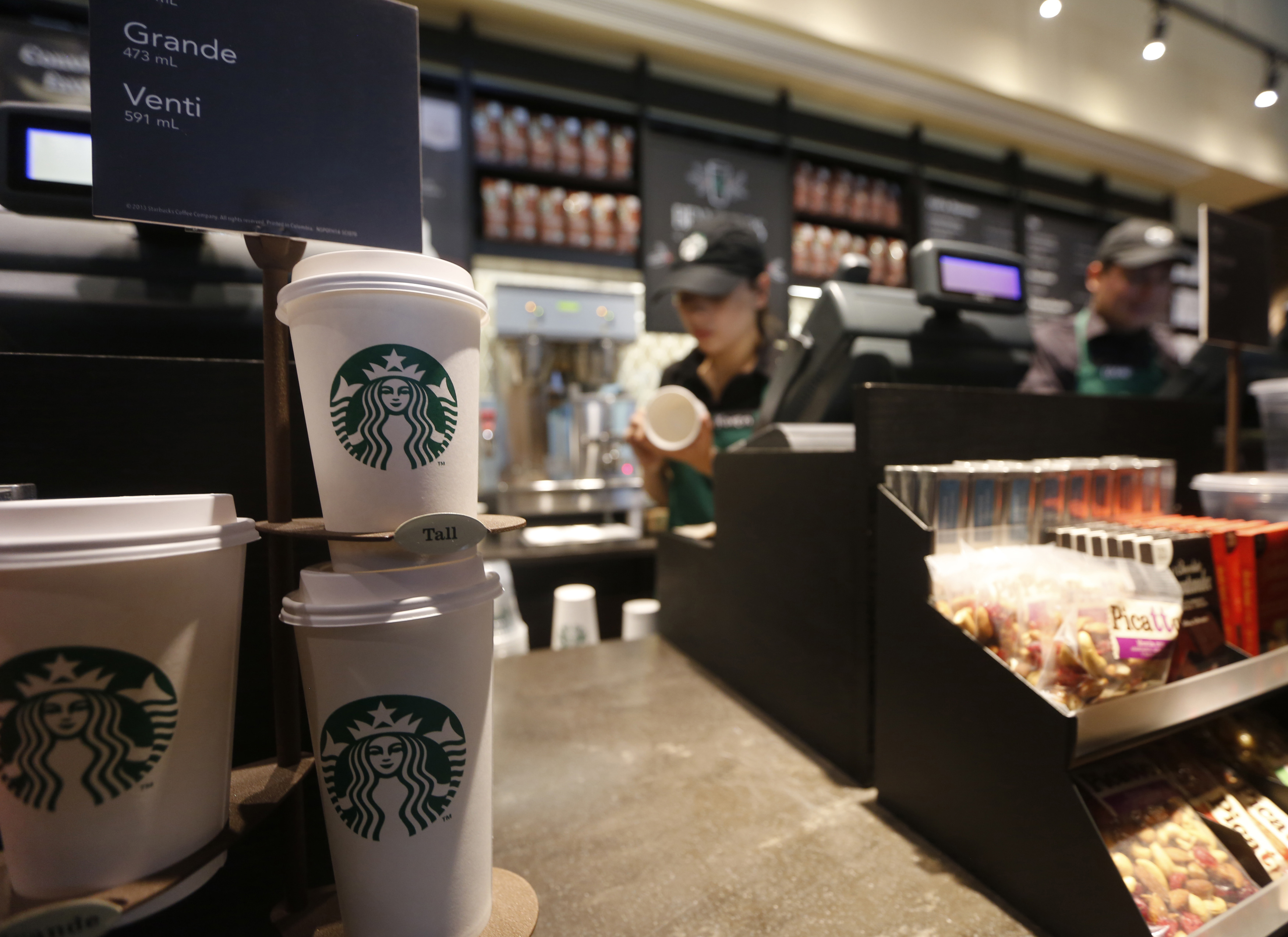 Paper cups of different sizes are seen on display at Starbuck's first Colombian store at 93 park in Bogota
