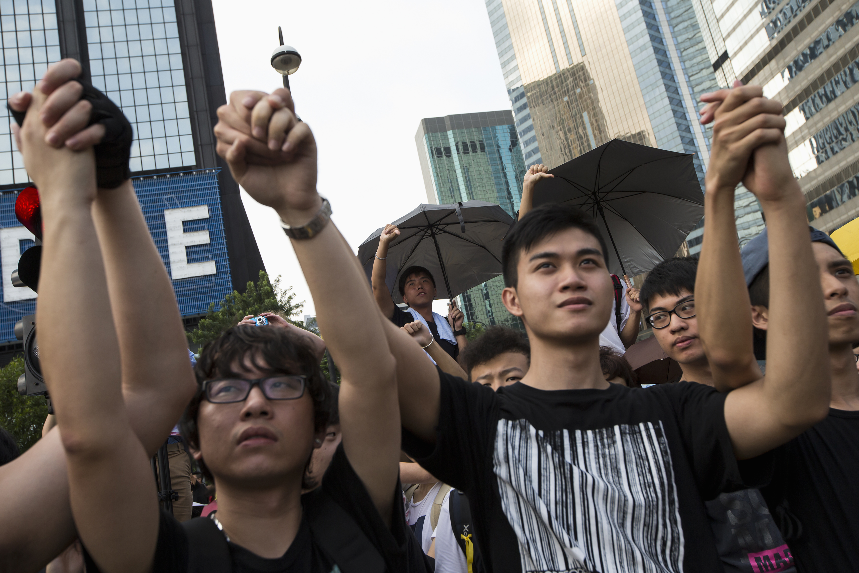 Student protesters gesture outside the Golden Bauhinia Square, venue of the official flag-raising ceremony for celebrations of China's National Day, in Hong Kong Oct. 1, 2014 (Tyrone Siu—Reuters)