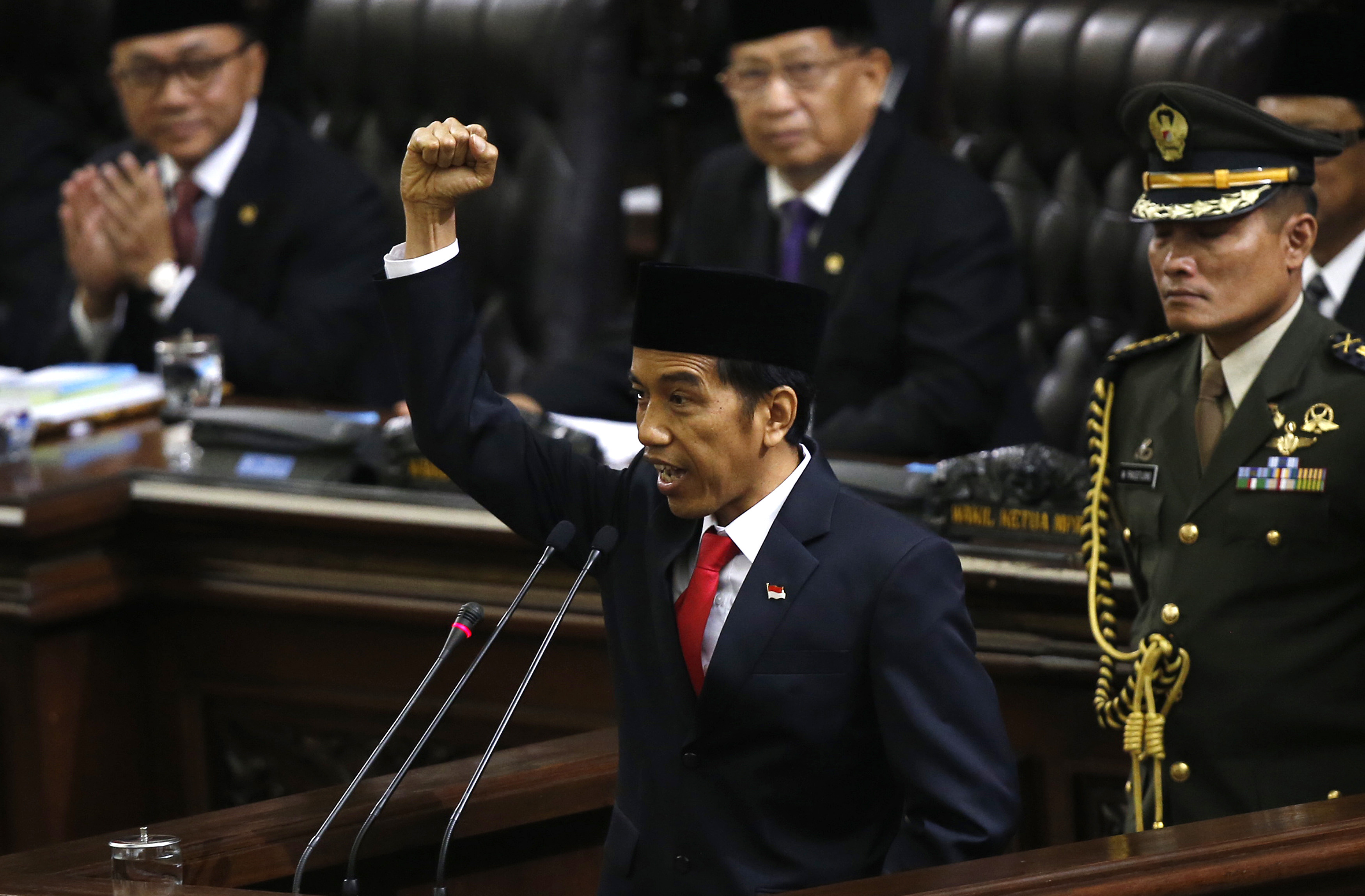 Indonesia's new President Joko Widodo shouts "<i>Merdeka</i>," meaning freedom, at the end of his speech, during his inauguration at the parliament's building in Jakarta on Oct. 20, 2014 (Darren Whiteside—Reuters)