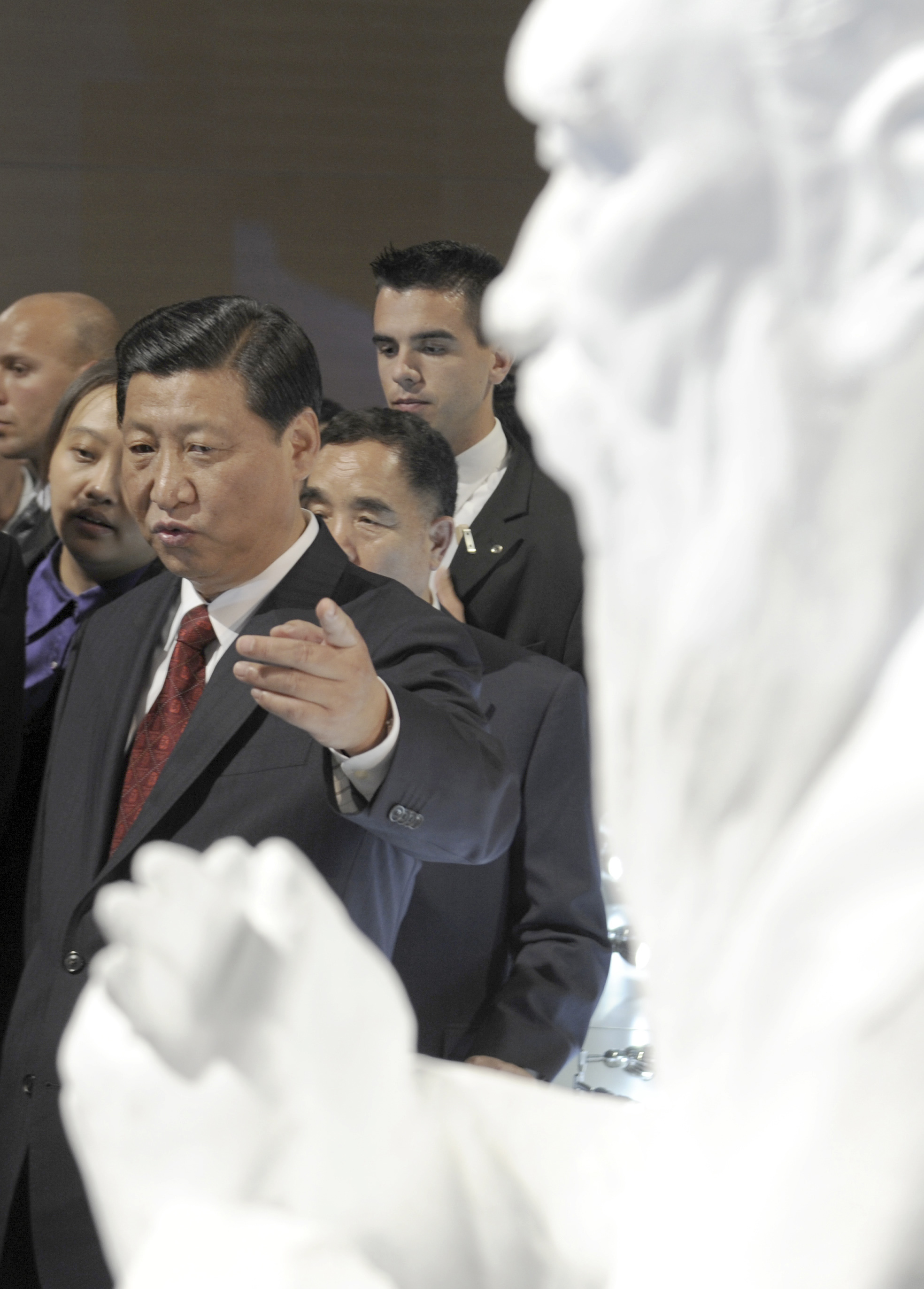 China's Vice President Xi Jinping points at the bust of Confucius in China pavilion of Frankfurt book fair