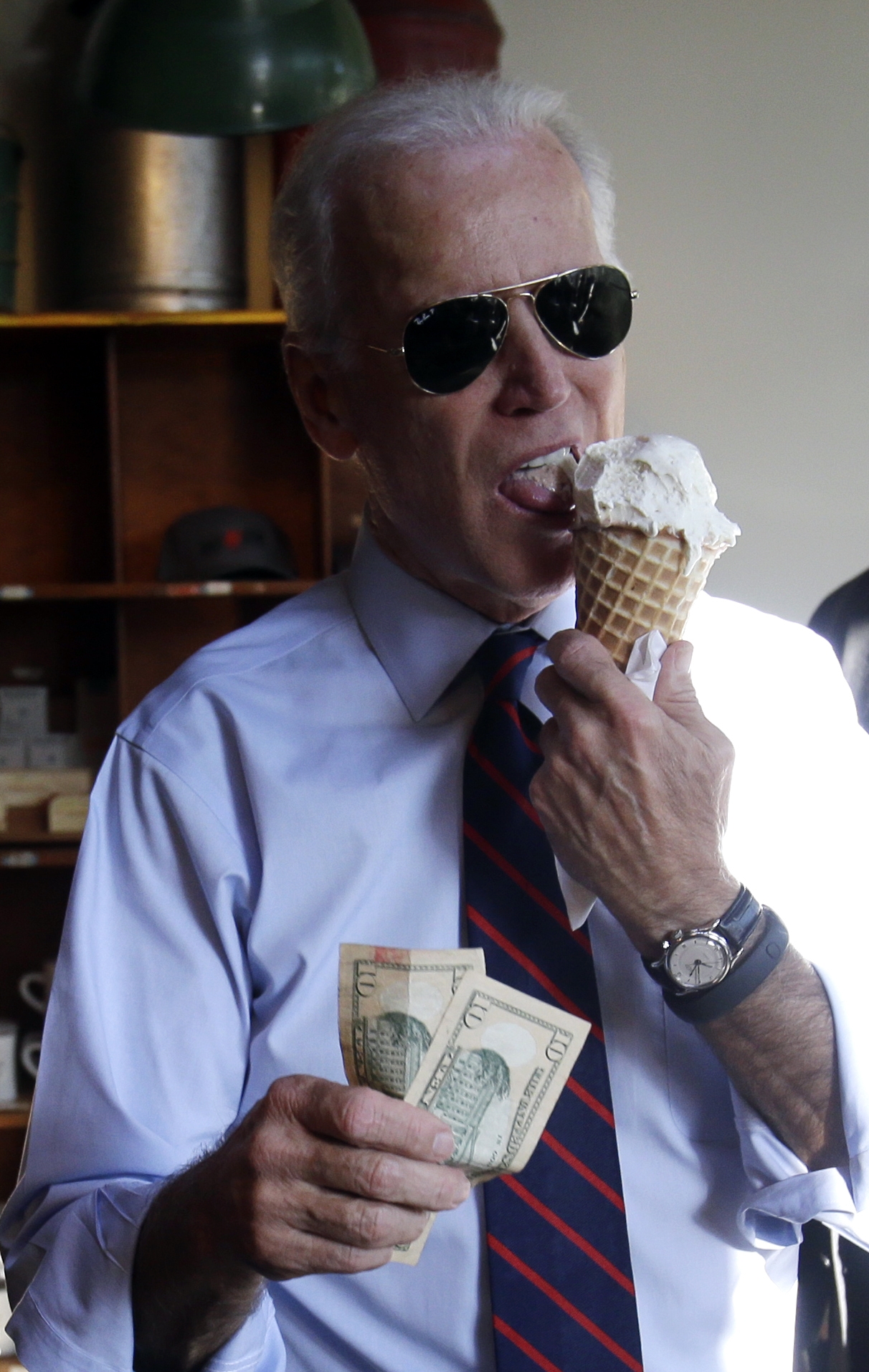 Vice President Joe Biden gets ready to pay for an ice cream cone after a campaign rally for U.S. Sen. Jeff Merkley in Portland, Ore., Wednesday, Oct. 8, 2014. (Don Ryan—AP)