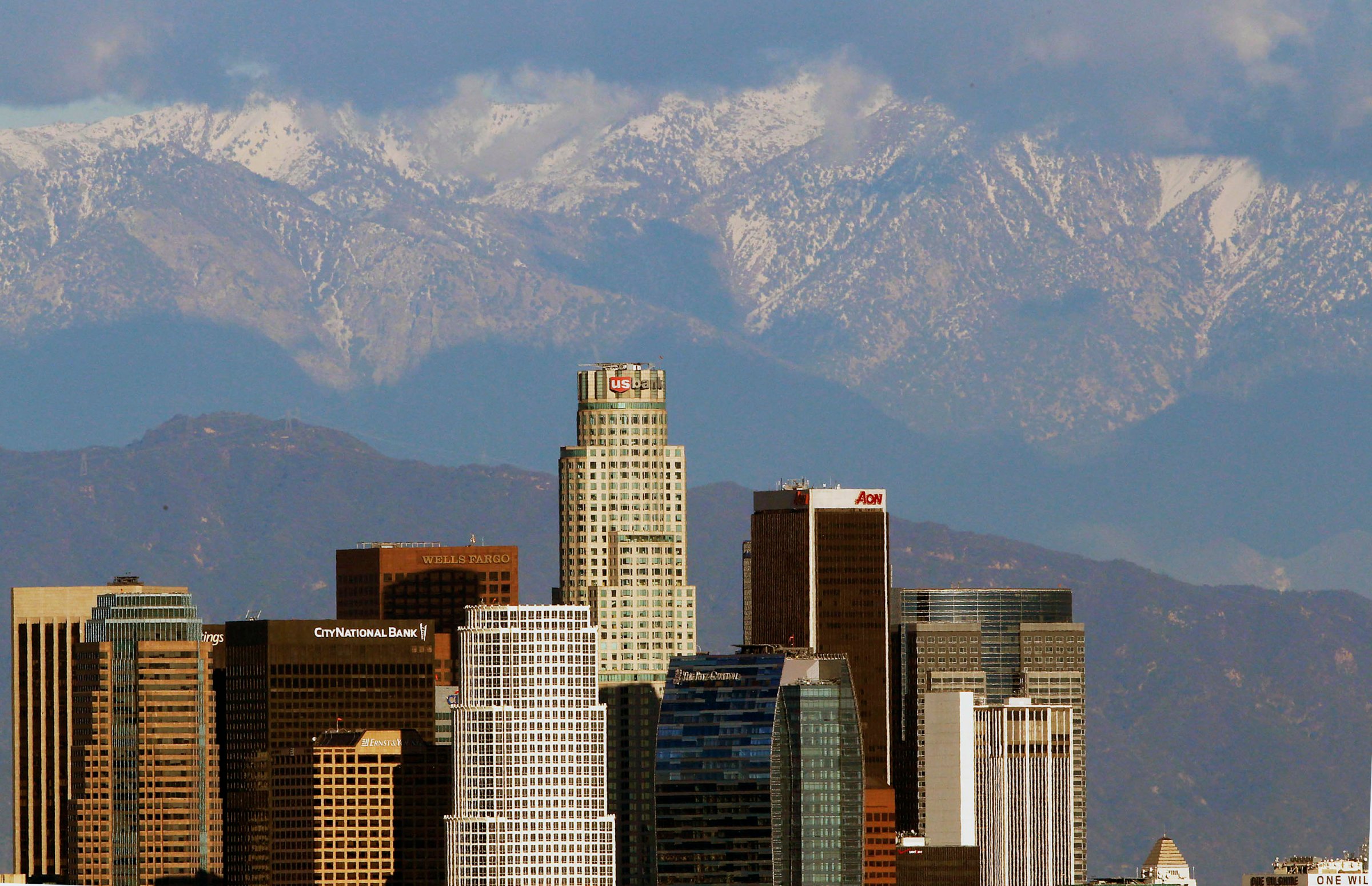 Snow covered San Gabriel Mountains rise behind the downtown Los Angeles skyline on Dec. 27, 2012.