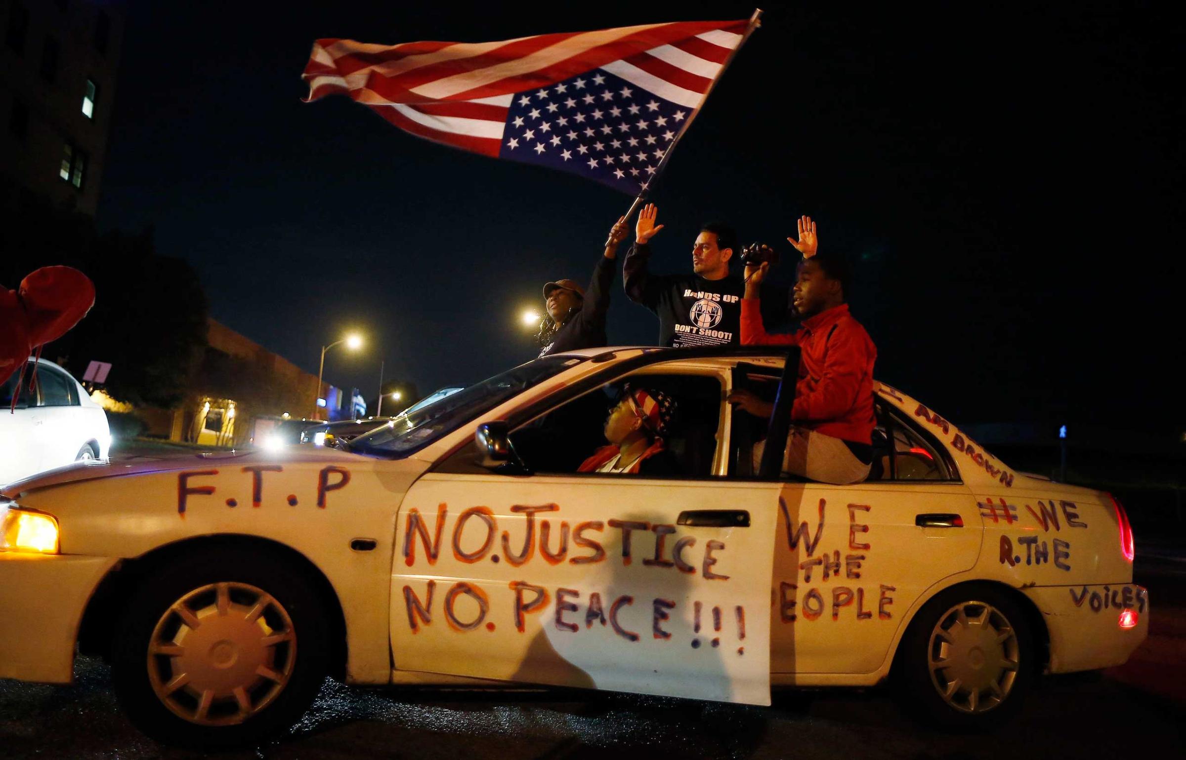 Protesters cheer after blocking an intersection after a vigil in St. Louis