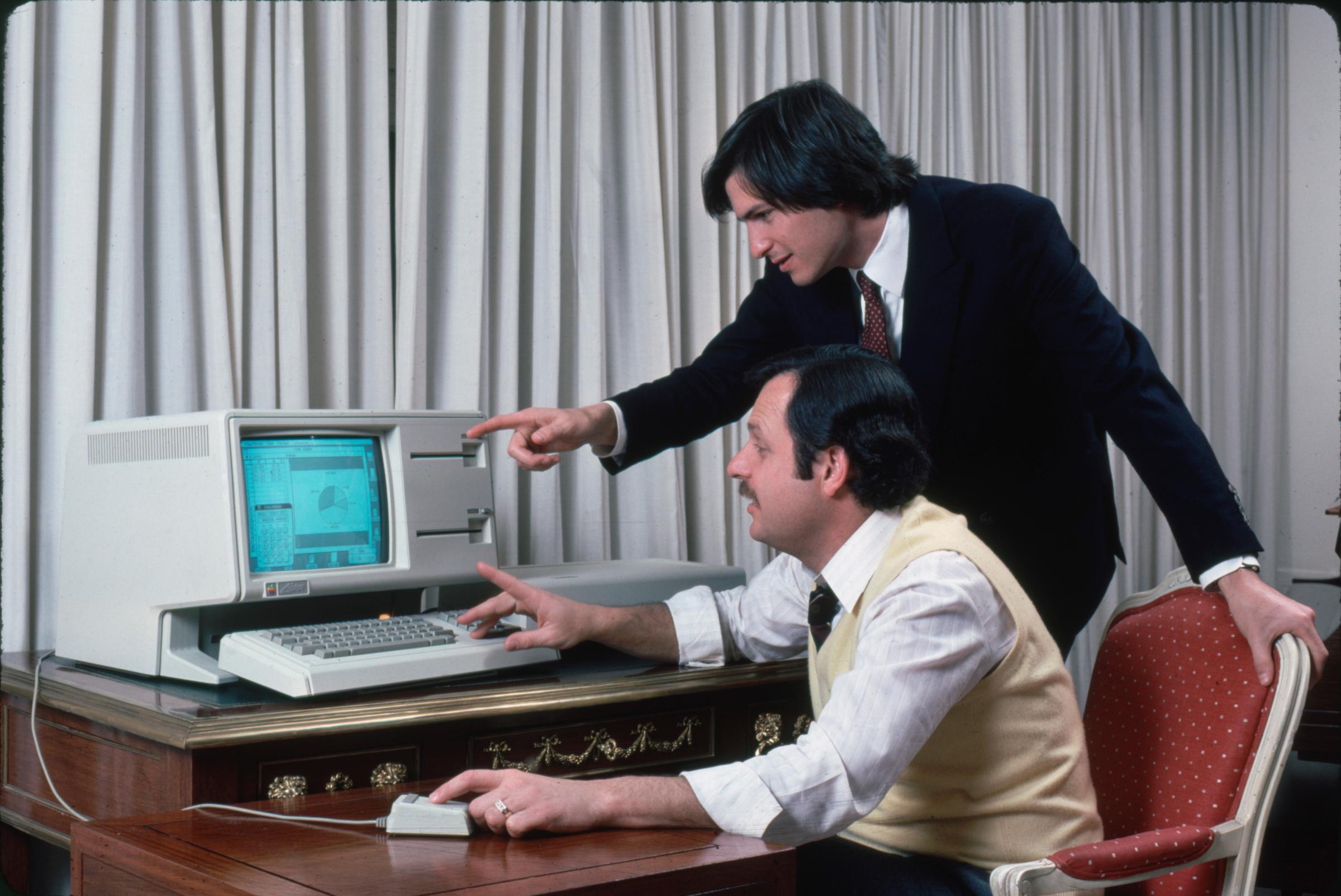 Apple computer Chrmn. Steve Jobs (R) and technician w. new LISA computer during press preview.