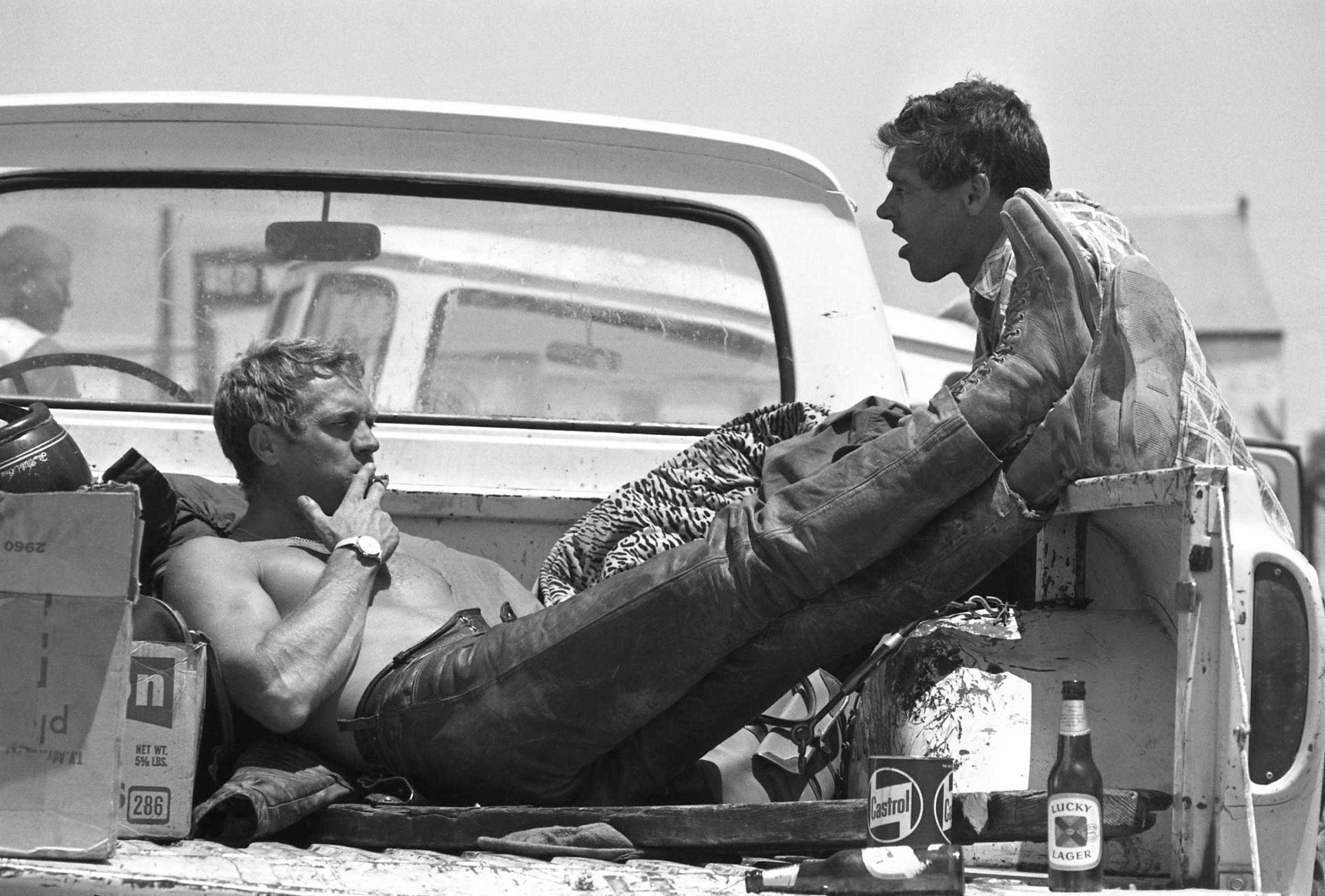 Steve McQueen takes a lunch break during a motorcycle race with Bud Ekins, his friend and stuntman for The Great Escape, 1963.