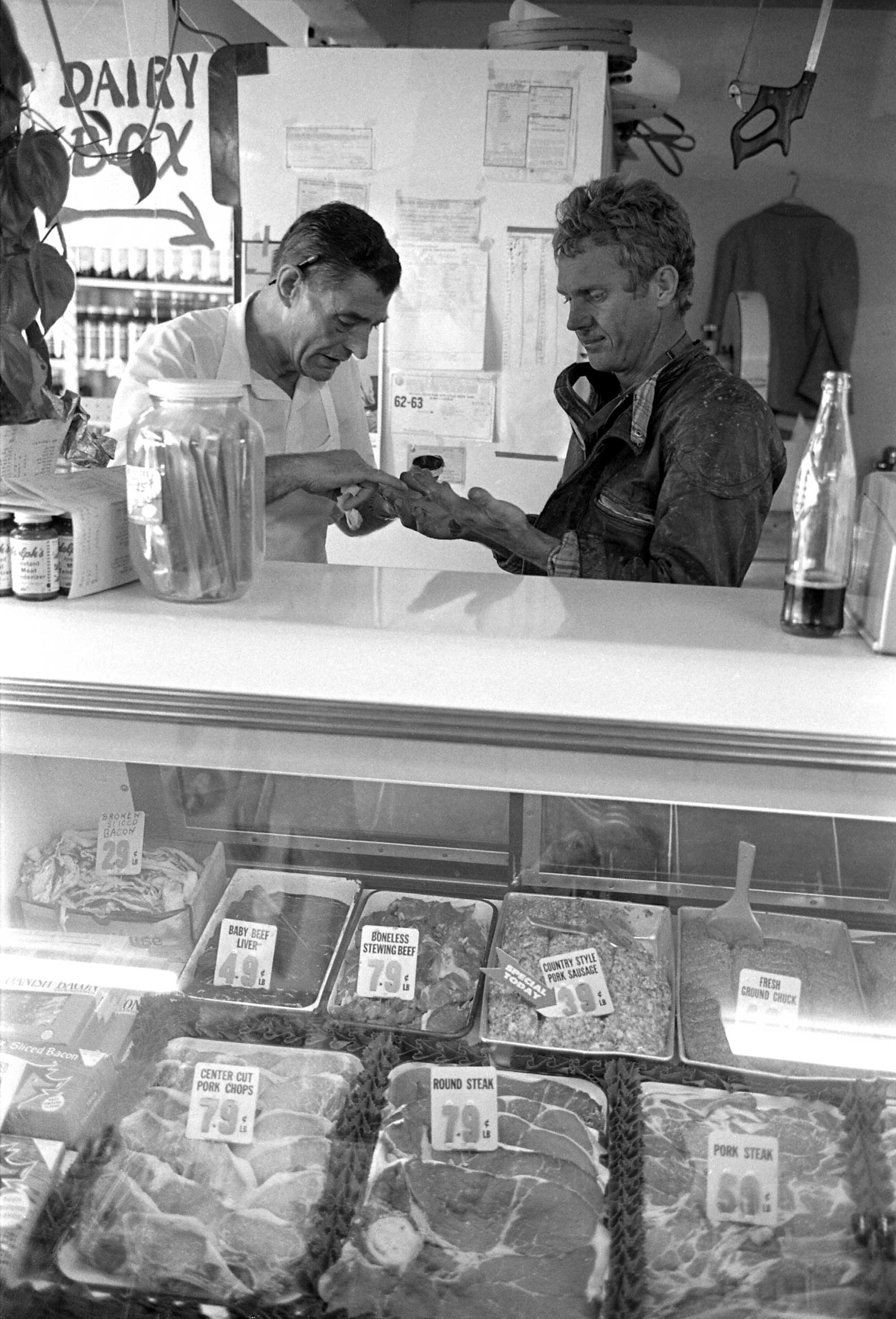 Steve McQueen makes a stop at a grocery store in Pearblossom, Calif., to get some treatment for race-bloodied hands, 1963.