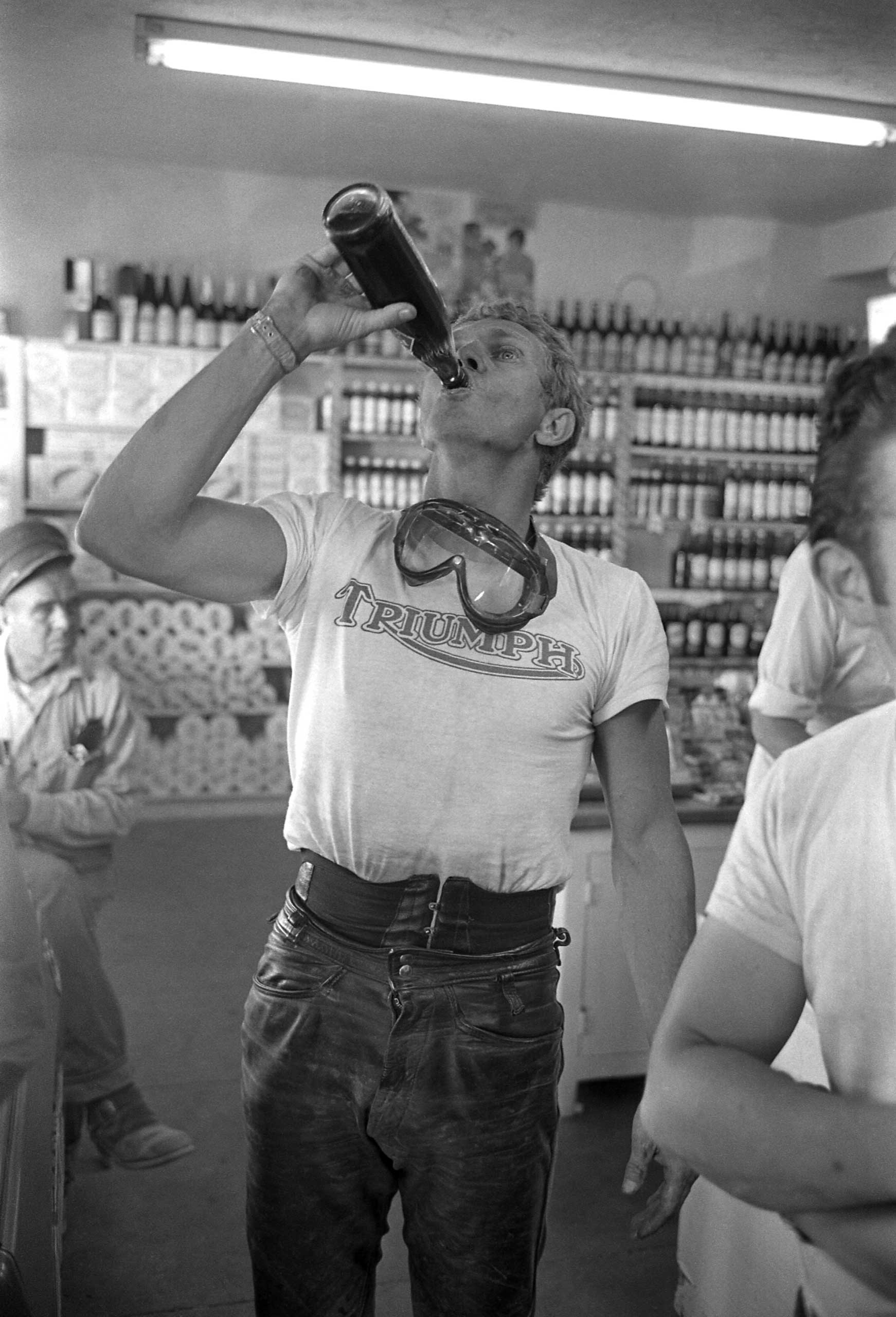 McQueen takes a deep swig of a tall, cool drink, 1963.