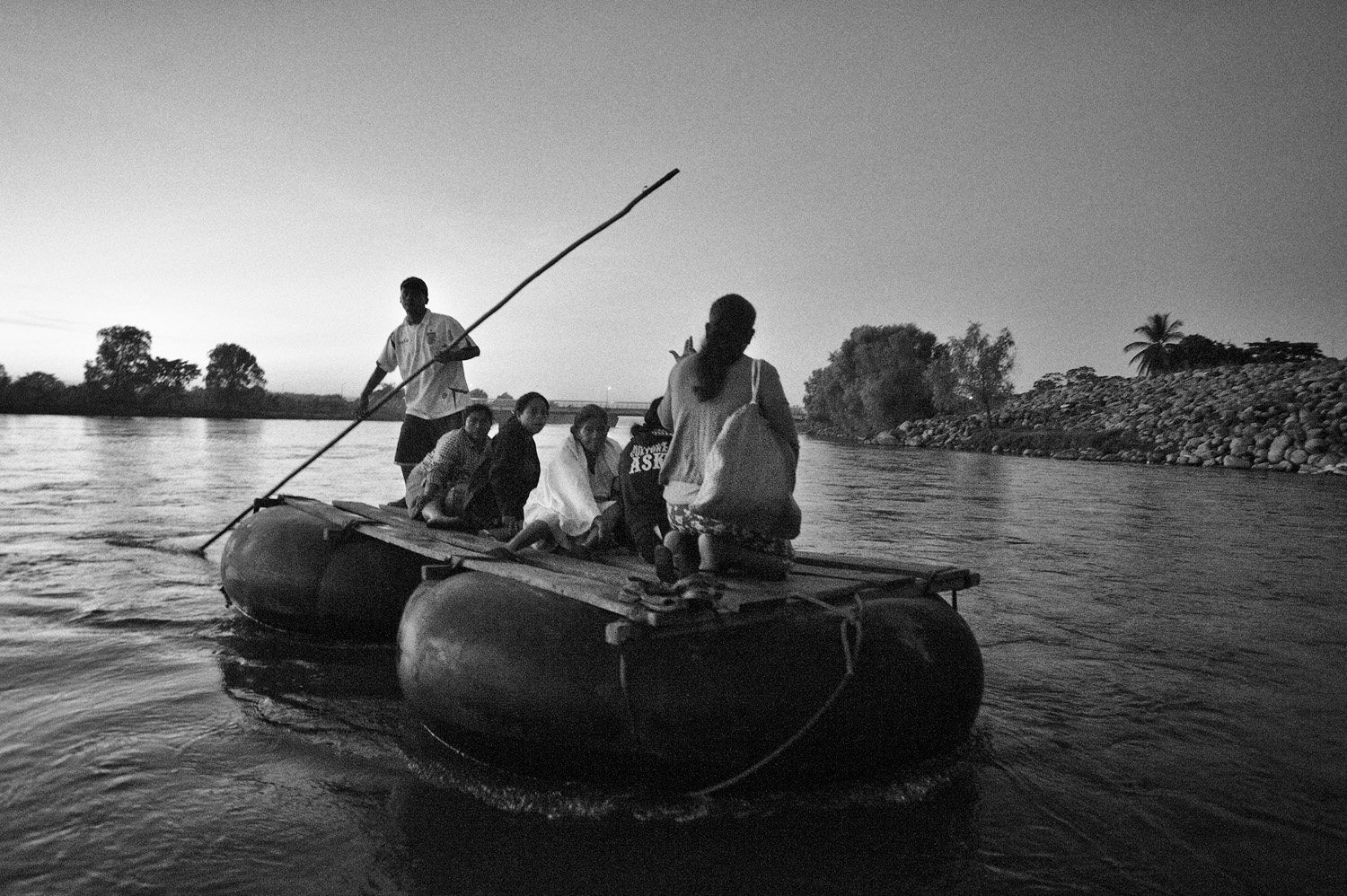Rafts are used to transport local people, migrants and goods across the Suchiate river between Guatemala and Mexico.