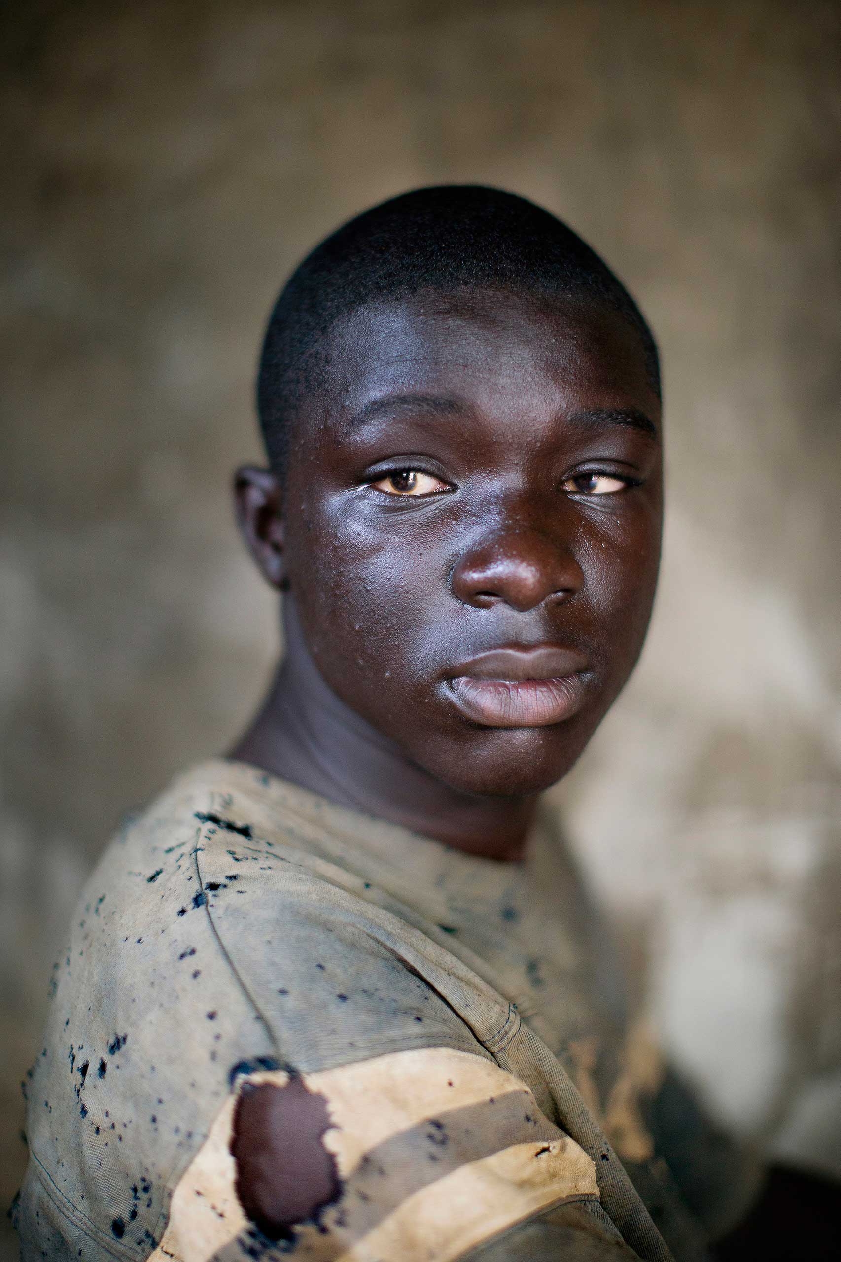 Blind boy in village hut, 2014.
