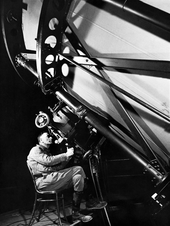 Astronomer Edwin Hubble peers though the eyepiece of the 100-inch Hooker telescope at California's Mt. Wilson Observatory. Originally published in the November 8, 1937, issue of LIFE.
