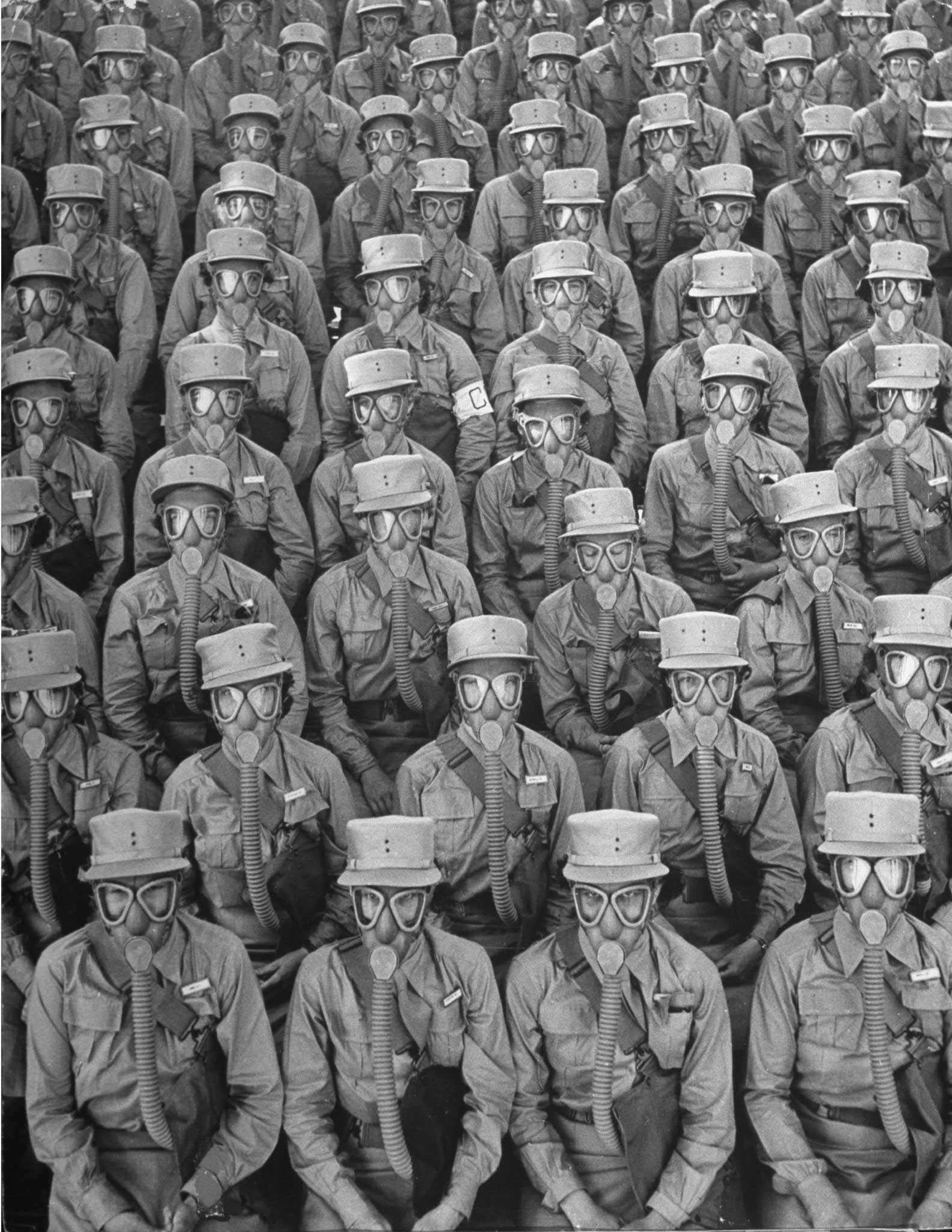 1942 | Row upon row of WACs (Women's Army Corps members) don gas masks for a training drill at Iowa's Fort Des Moines. Originally published in the September 7, 1942, issue of LIFE.
