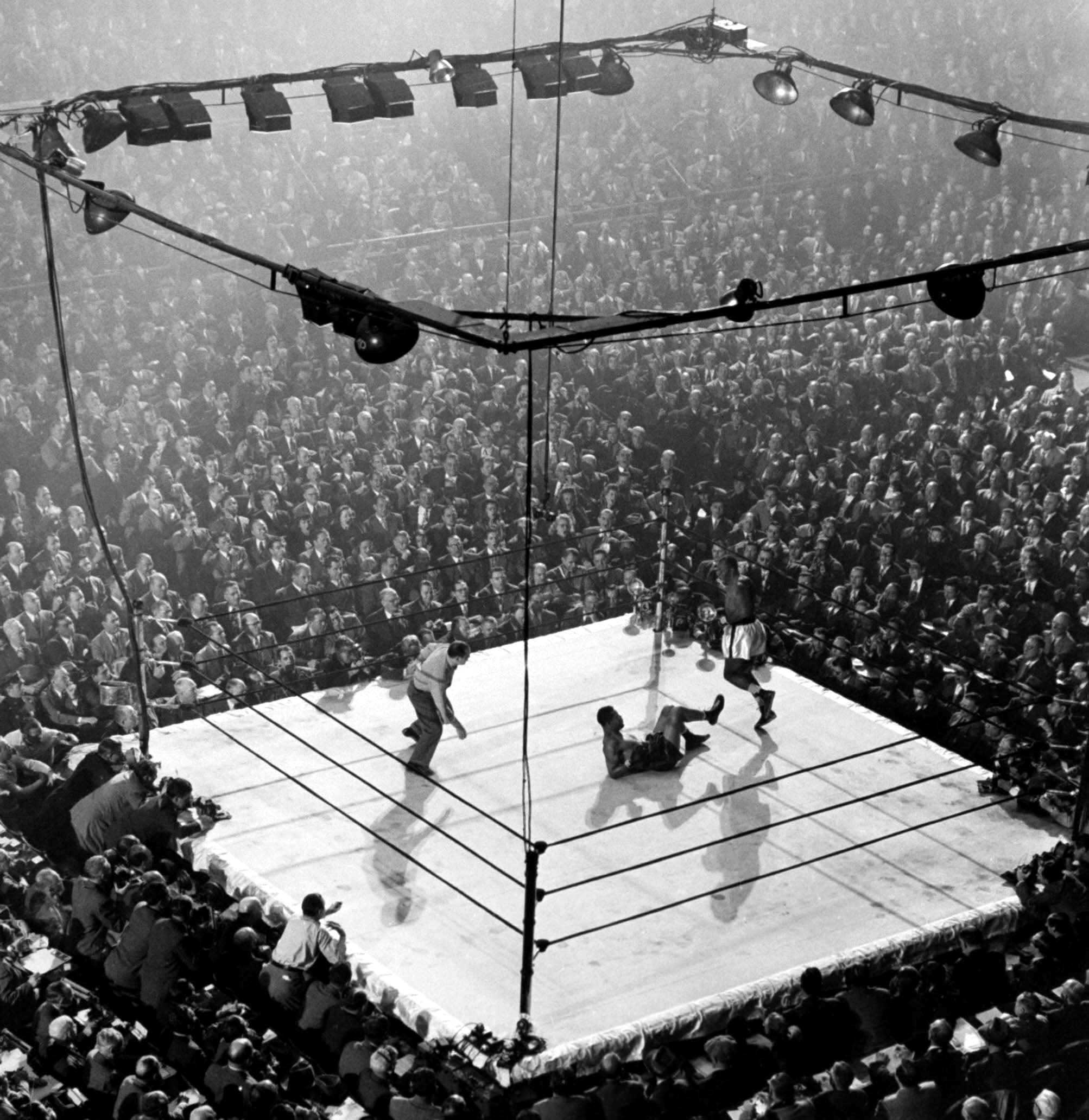 1947 | Heavyweight champ Joe Louis lies on the canvas at (the old, original) Madison Square Garden in New York after being floored by contender Jersey Joe Walcott in a December 1947 title match. Louis came back to win by a controversial decision. Originally published in the December 15, 1947 issue of LIFE.