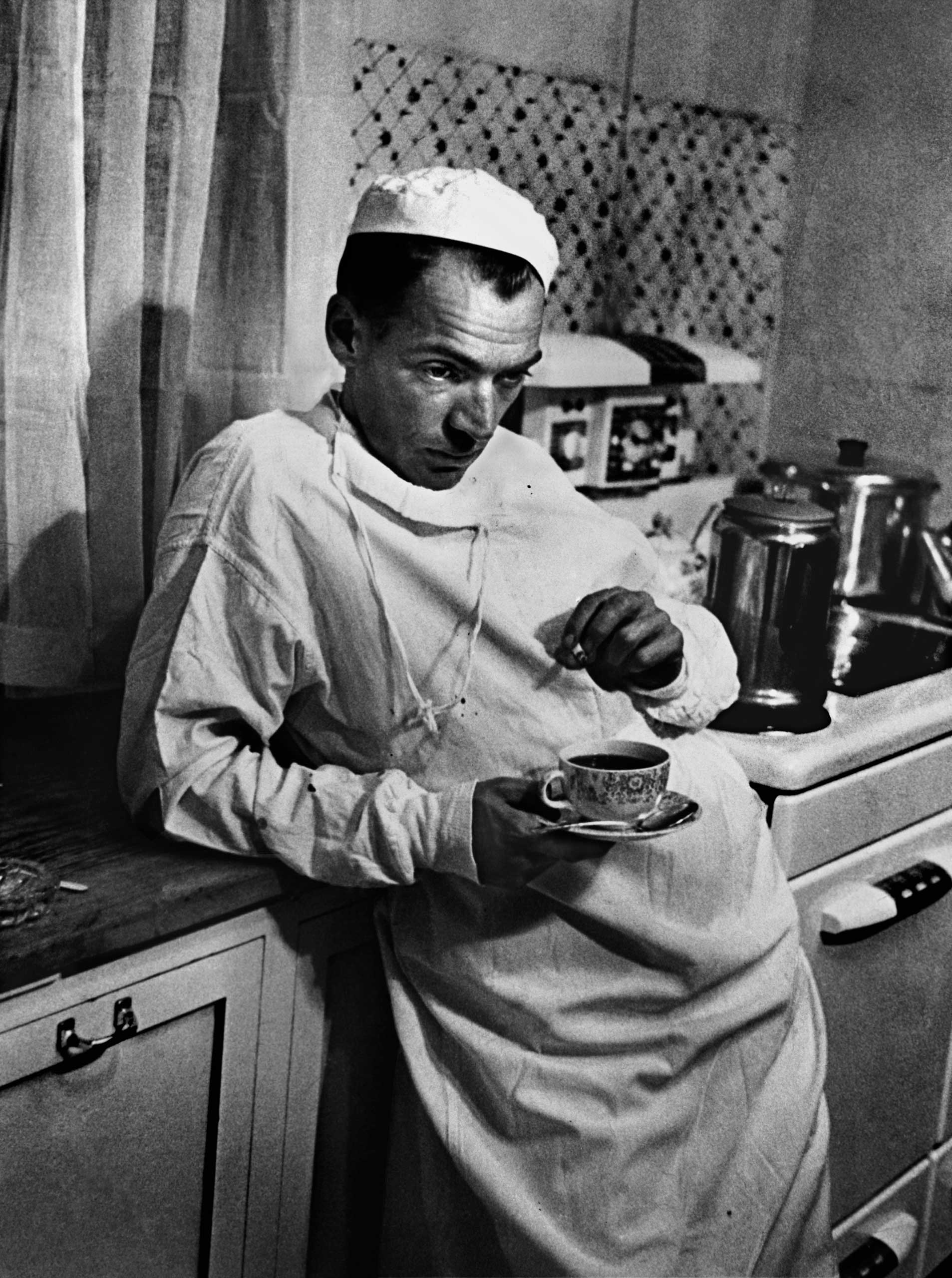 1948 | Dr. Ernest Ceriani, a general practitioner in tiny Kremmling, Colorado, stands in the town's hospital kitchen after a surgery that lasted until 2 AM. This was the final image in W. Eugene Smith's groundbreaking photo essay,  Country Doctor,  originally published in the September 20, 1948, issue of LIFE.