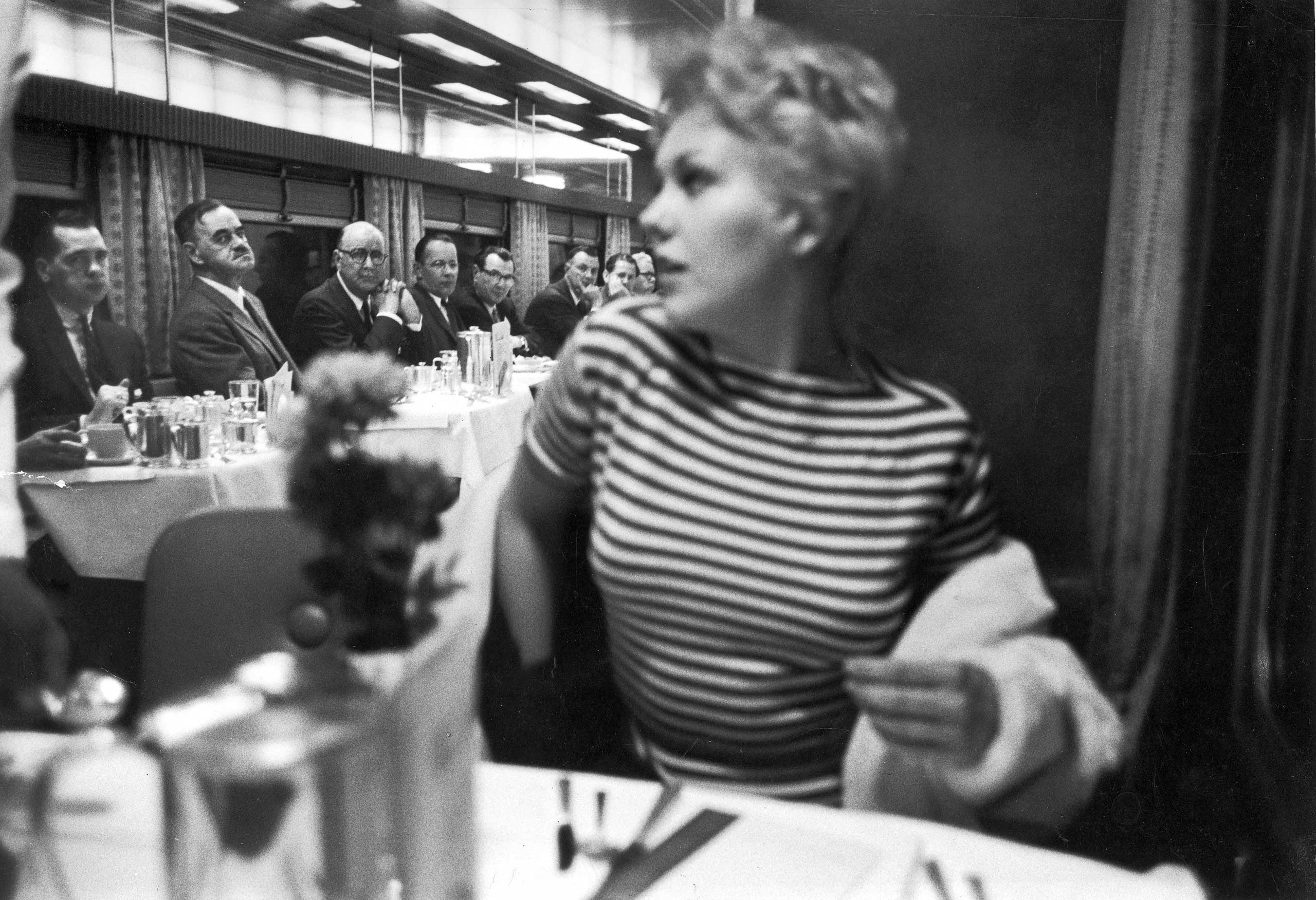 1956 |  Eyes right  is executed with near-military precision by men aboard a New York-bound 20th Century Limited train as movie star Kim Novak eases into her seat in the dining car. Originally published in the March 5, 1956, issue of LIFE.