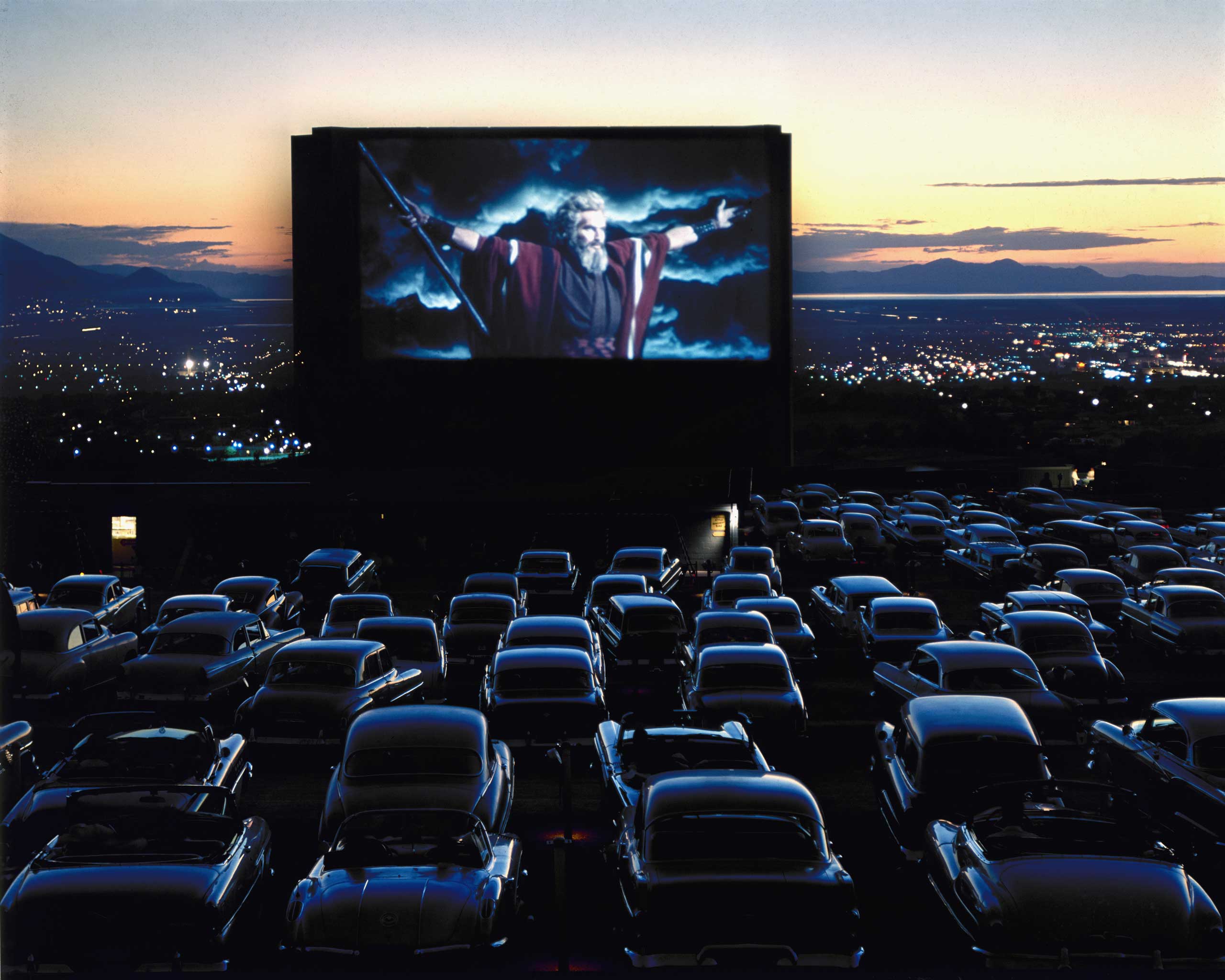 1958 | On the screen of a drive-in theater in Utah, Charlton Heston, as Moses in the The Ten Commandments, throws his arms wide before what appears to be a congregation of cars at prayer. Originally published in the December 22, 1958, issue of LIFE.
