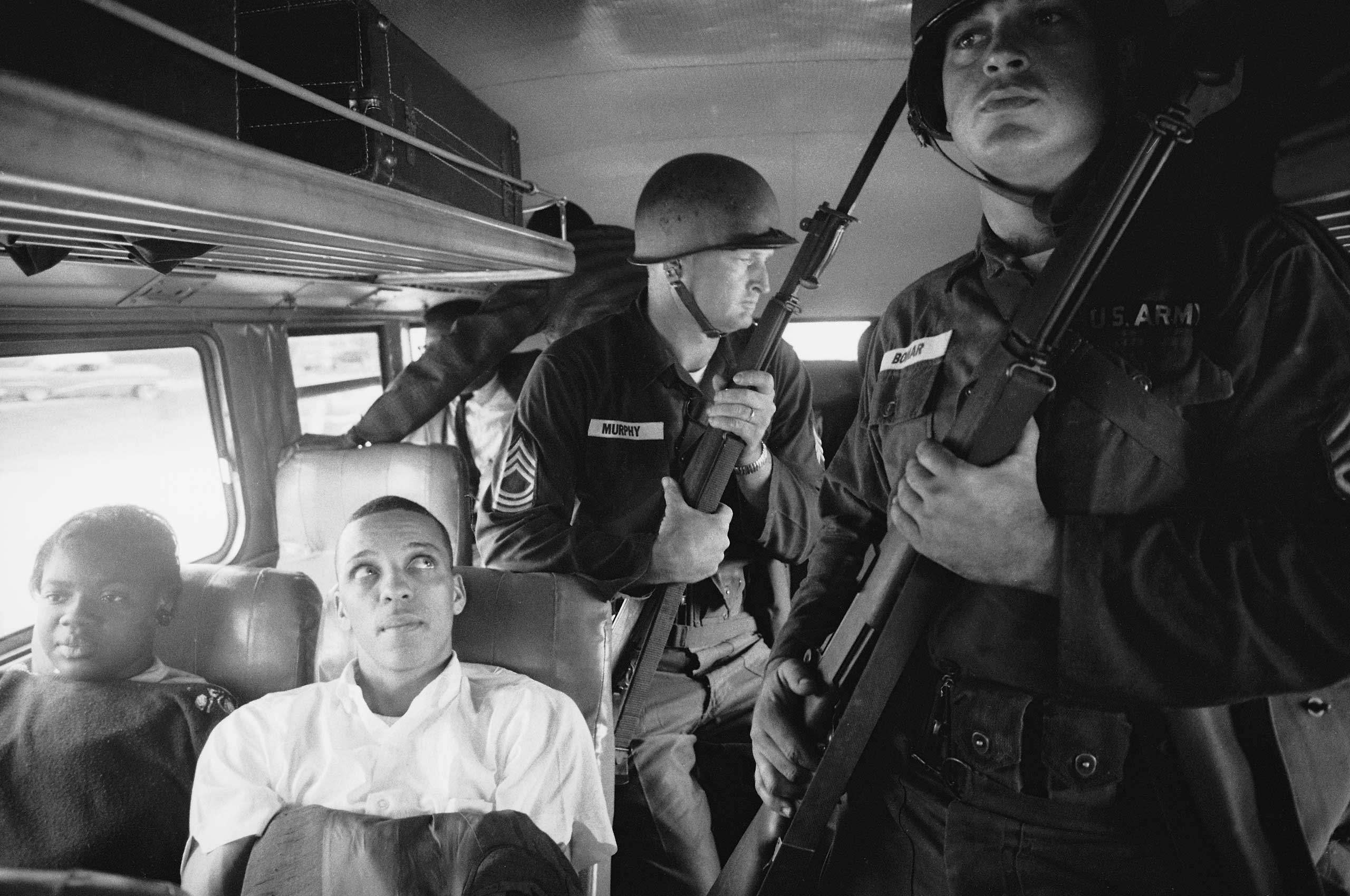 1961 | Freedom Riders Julia Aaron and David Dennis sit aboard an interstate bus as they and 25 other civil rights activists are escorted by Mississippi National Guardsmen on a violence-marred trip between Montgomery, Alabama, and Jackson, Mississippi. Originally published in the June 2, 1961, issue of LIFE.