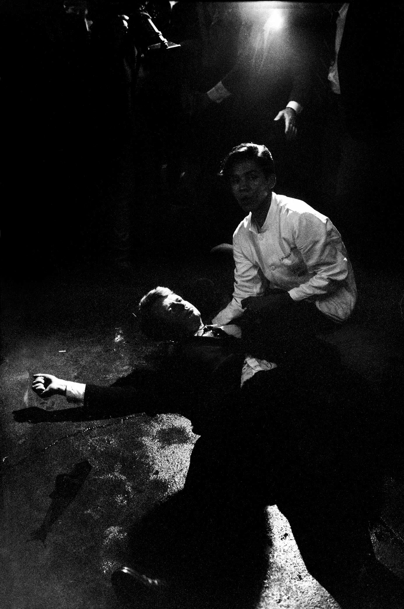 1968 | Senator Robert Kennedy lies in a pool of his own blood on the floor of the kitchen at Los Angeles' Ambassador Hotel, June 5, 1968, after being shot by Jordanian-born assassin Sirhan Sirhan. A dazed, frightened hotel busboy, Juan Romero, tries to comfort the mortally wounded presidential candidate, who died hours later. Robert Kennedy was 42 years old. Originally published in the June 14, 1968, issue of LIFE.