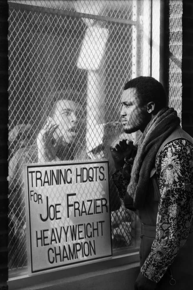 Challenger Muhammad Ali taunts heavyweight champ Joe Frazier at Frazier's training camp in Pennsylvania ahead of their March 1971 "Fight of the Century" title bout at Madison Square Garden. Frazier retained the championship belt in a unanimous 15-round decision. Originally published in the March 5, 1971, issue of LIFE.