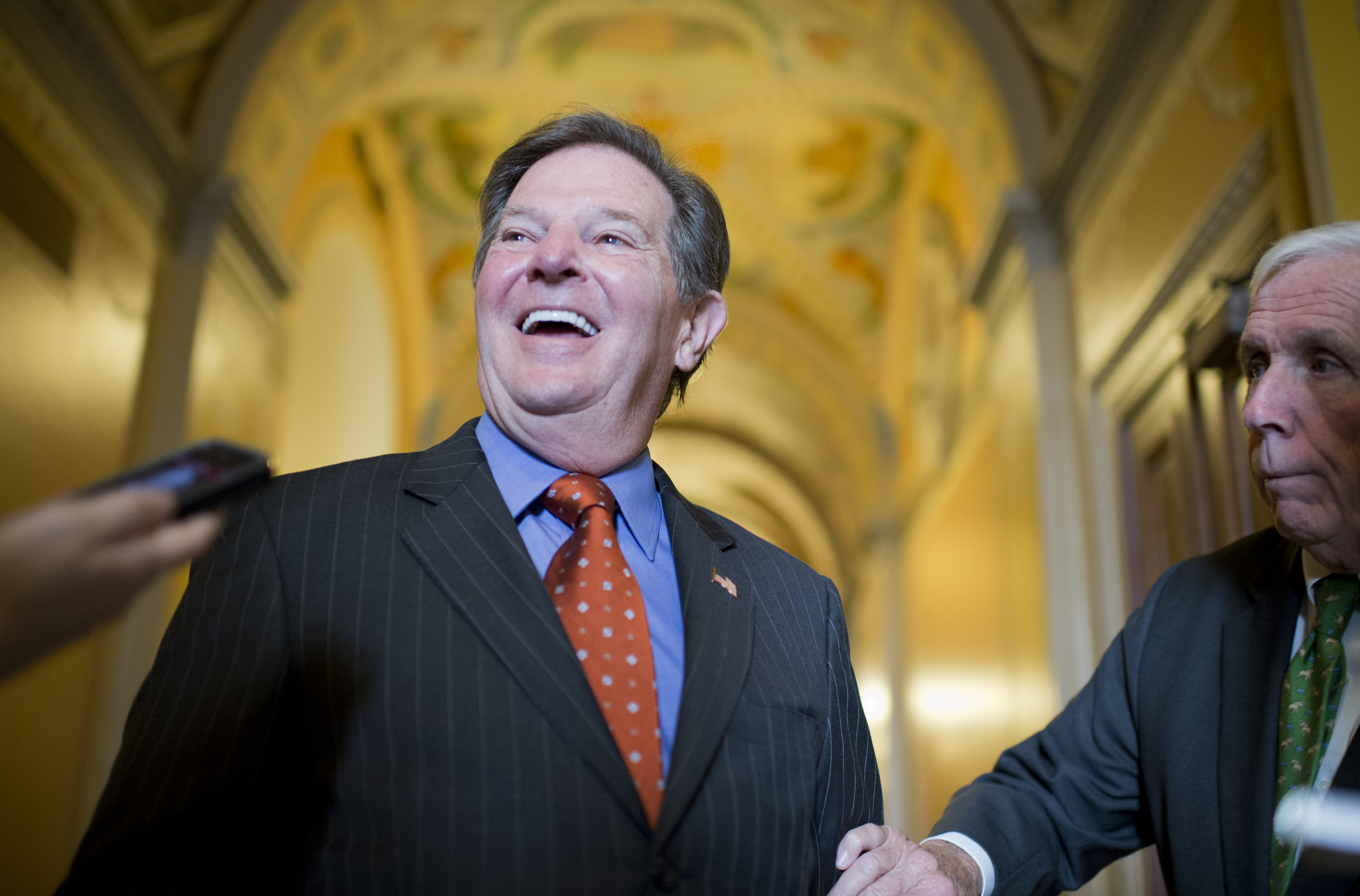 Former Rep. Tom Delay, R-Texas, talks with reporters after a lunch meeting of the Texas Republicans in the capitol on the day his conviction for corruption was overturned by a Texas appeals court. (Tom Williams&mdash;CQ-Roll Call,Inc.)