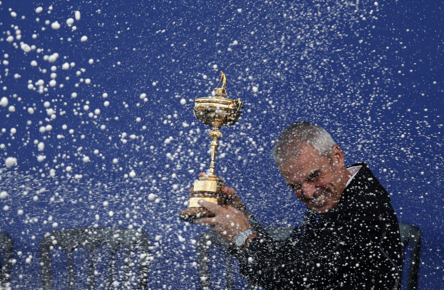 Captain of Team Europe Paul McGinley of Ireland is sprayed with champagne as he holds the Ryder Cup trophy on the final day of the Ryder Cup golf tournament at the Gleneagles Hotel in Gleneagles, Scotland, on Sept. 28, 2014.