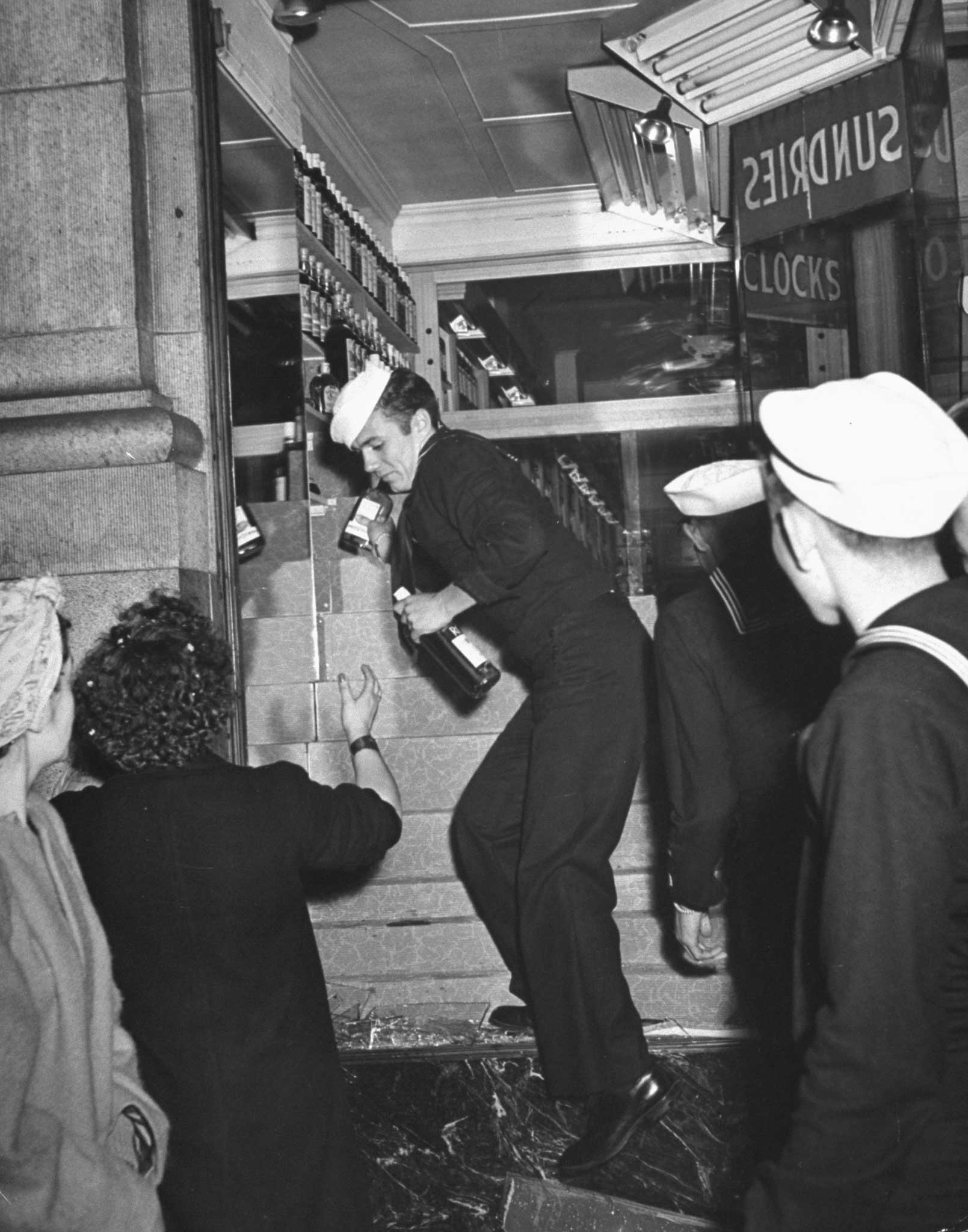 "In San Francisco sailors break into a liquor store and pilfer the stock. Revel turned into a riot as tense servicemen, reprieved from impending Pacific war-zone duty, defaced statues, over-turned street cars, ripped down bond booths, attacked girls. The toll: 1,000 casualties."