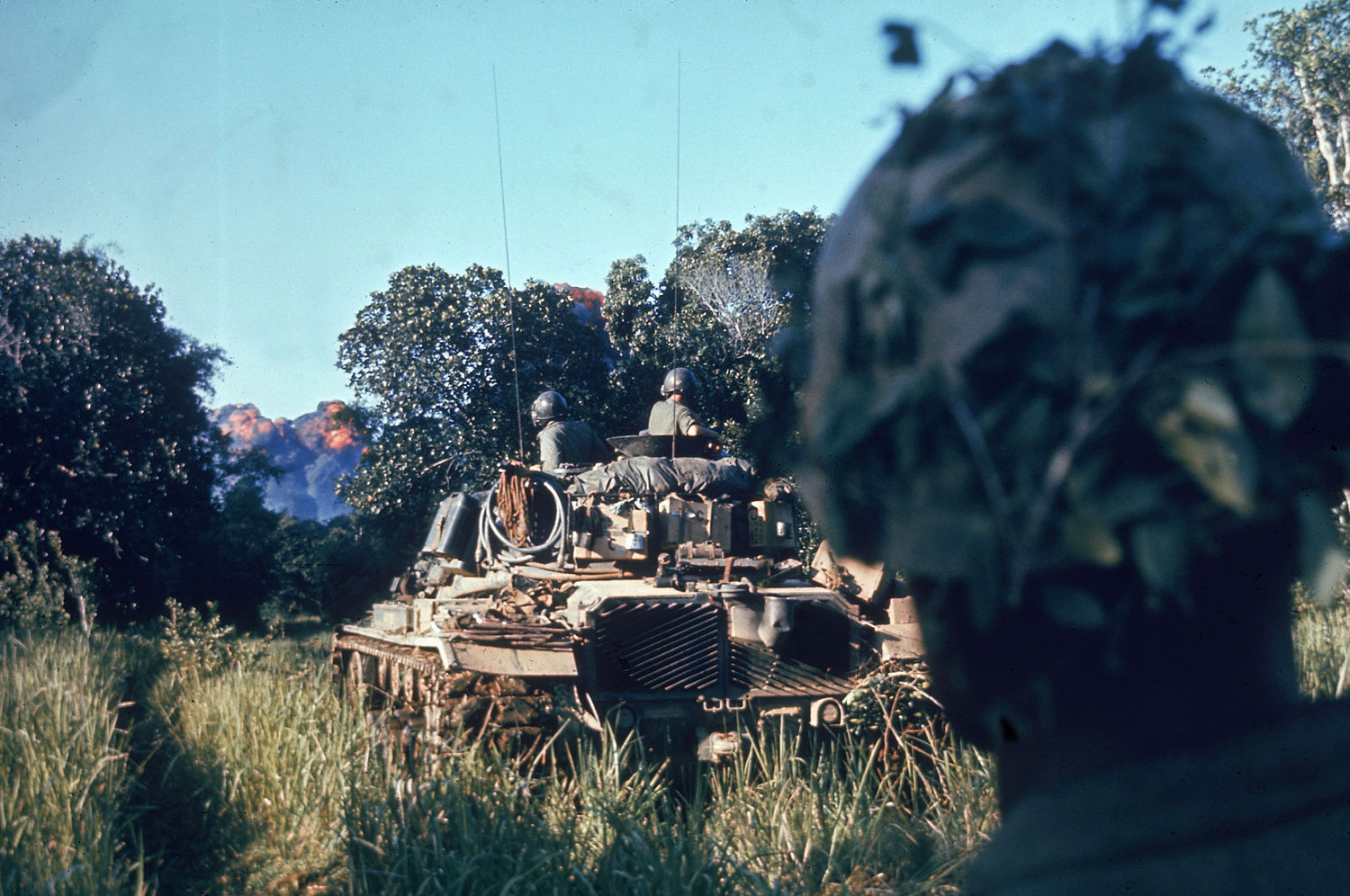 "Escorted by tanks and supported by air strikes that sear the jungle just ahead, troops of the Second Battalion, Fifth Marines, begin a sweep." Vietnam, October 1966.