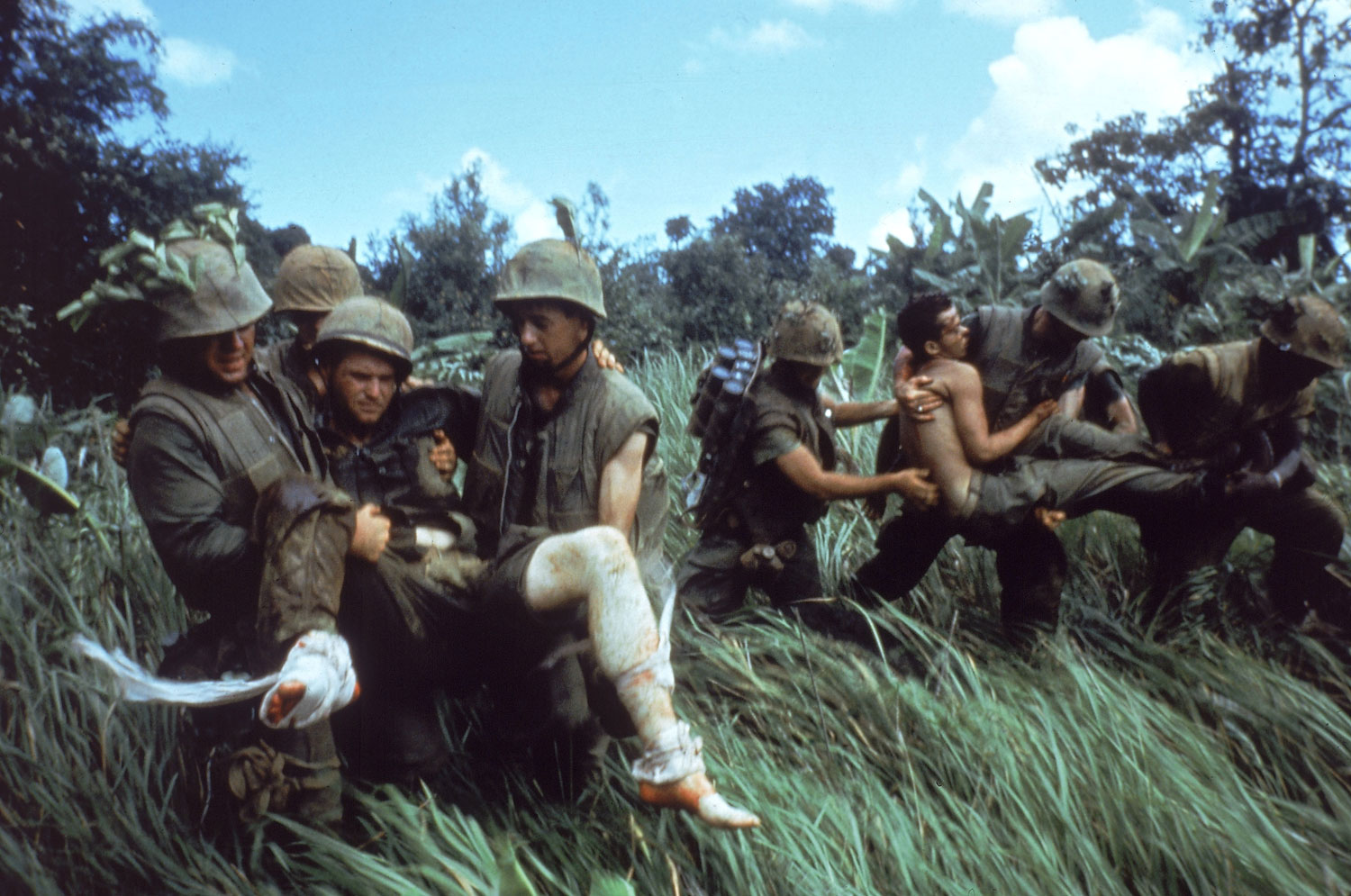 Not published in LIFE. U.S. Marines carry their wounded during a firefight near the southern edge of the DMZ, Vietnam, October 1966.