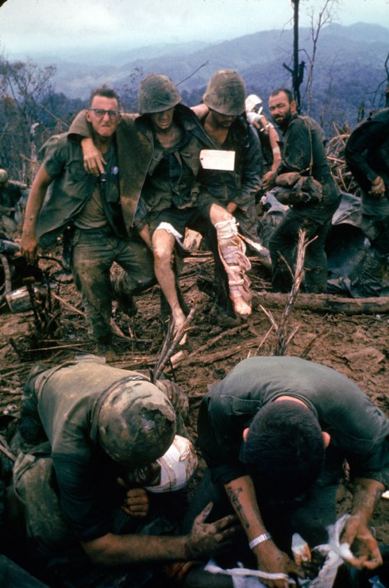American Marines aid wounded comrades during Operation Prairie near the DMZ during the Vietnam War, October 1966.