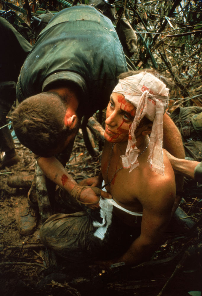 Not published in LIFE. A dazed, wounded American Marine gets bandaged during Operation Prairie near the DMZ during the Vietnam War, October 1966.