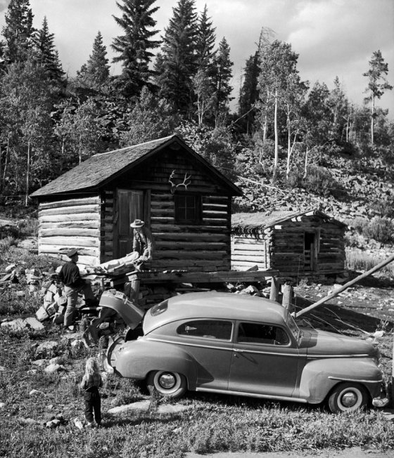 Not published in LIFE. Doctor Ceriani and town marshal Chancey Van Pelt carry a patient from a cabin in the hills near Kremmling, Colo., 1948.